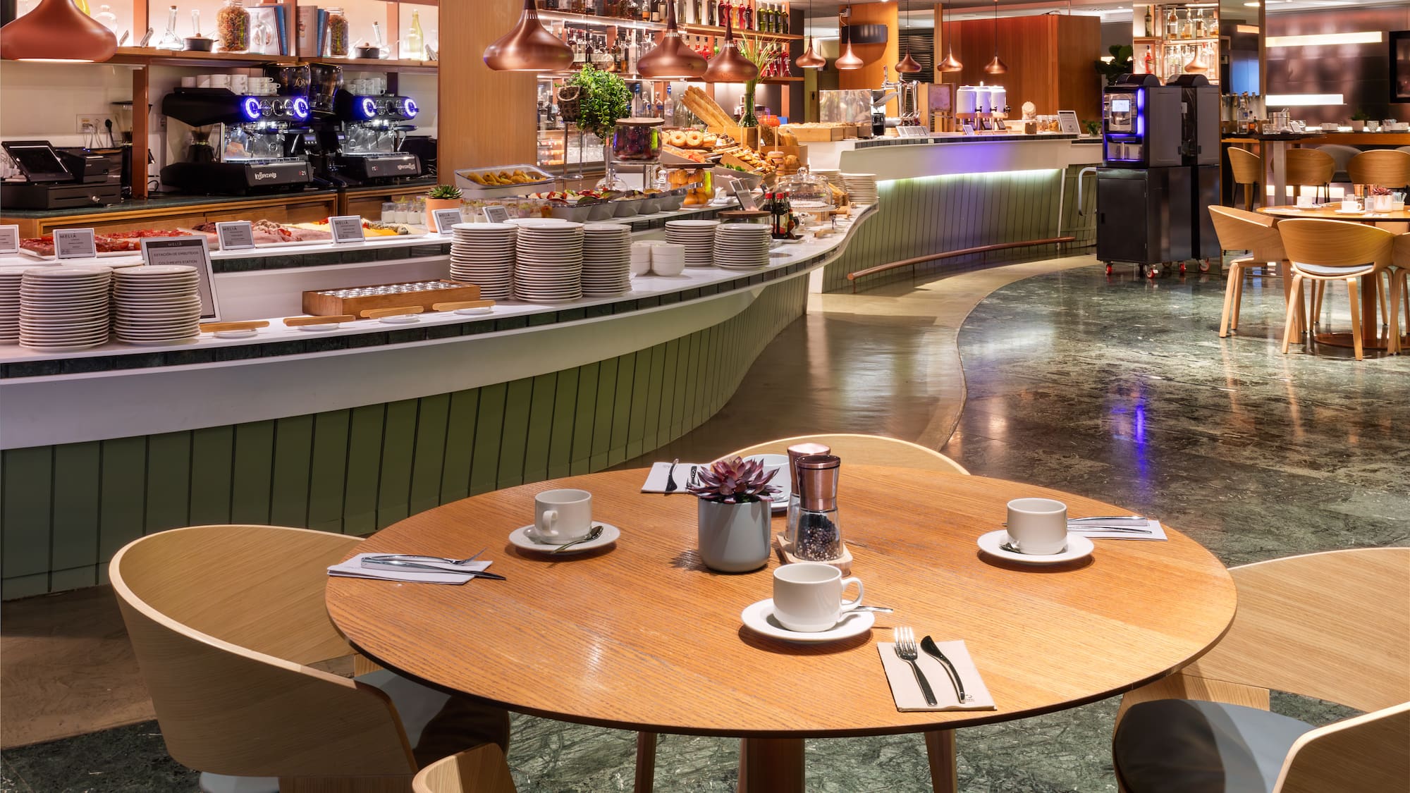 a restaurant with a counter and tables