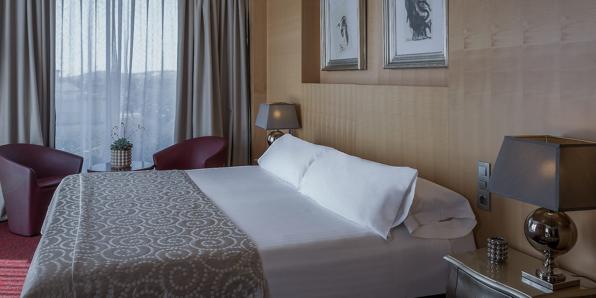 a bed with pillows and a lamp in a room