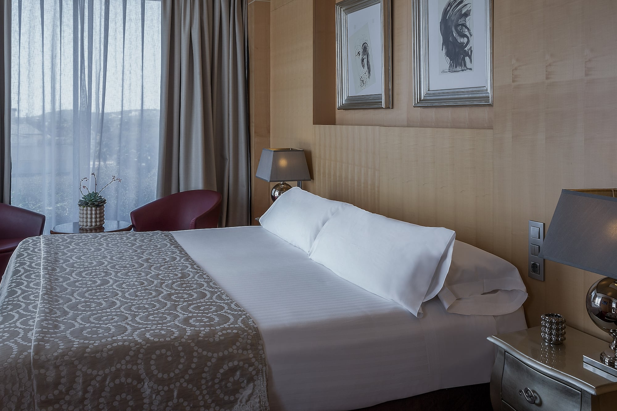 a bed with pillows and a lamp in a room