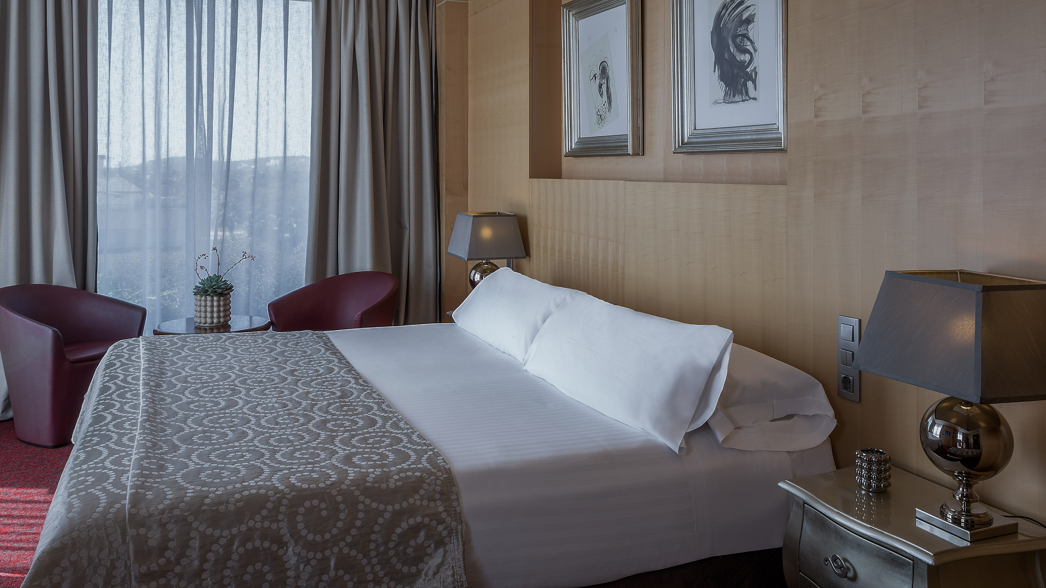 a bed with pillows and a lamp in a room