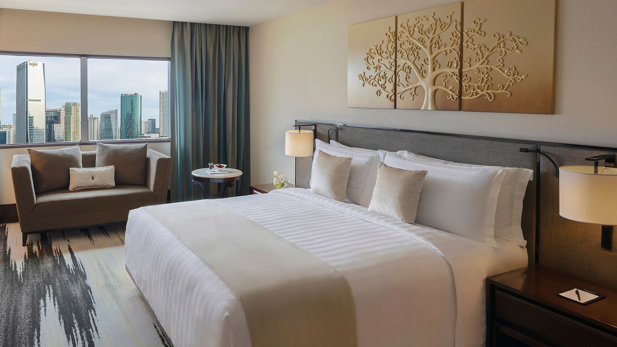 a hotel room with a bed and chairs
