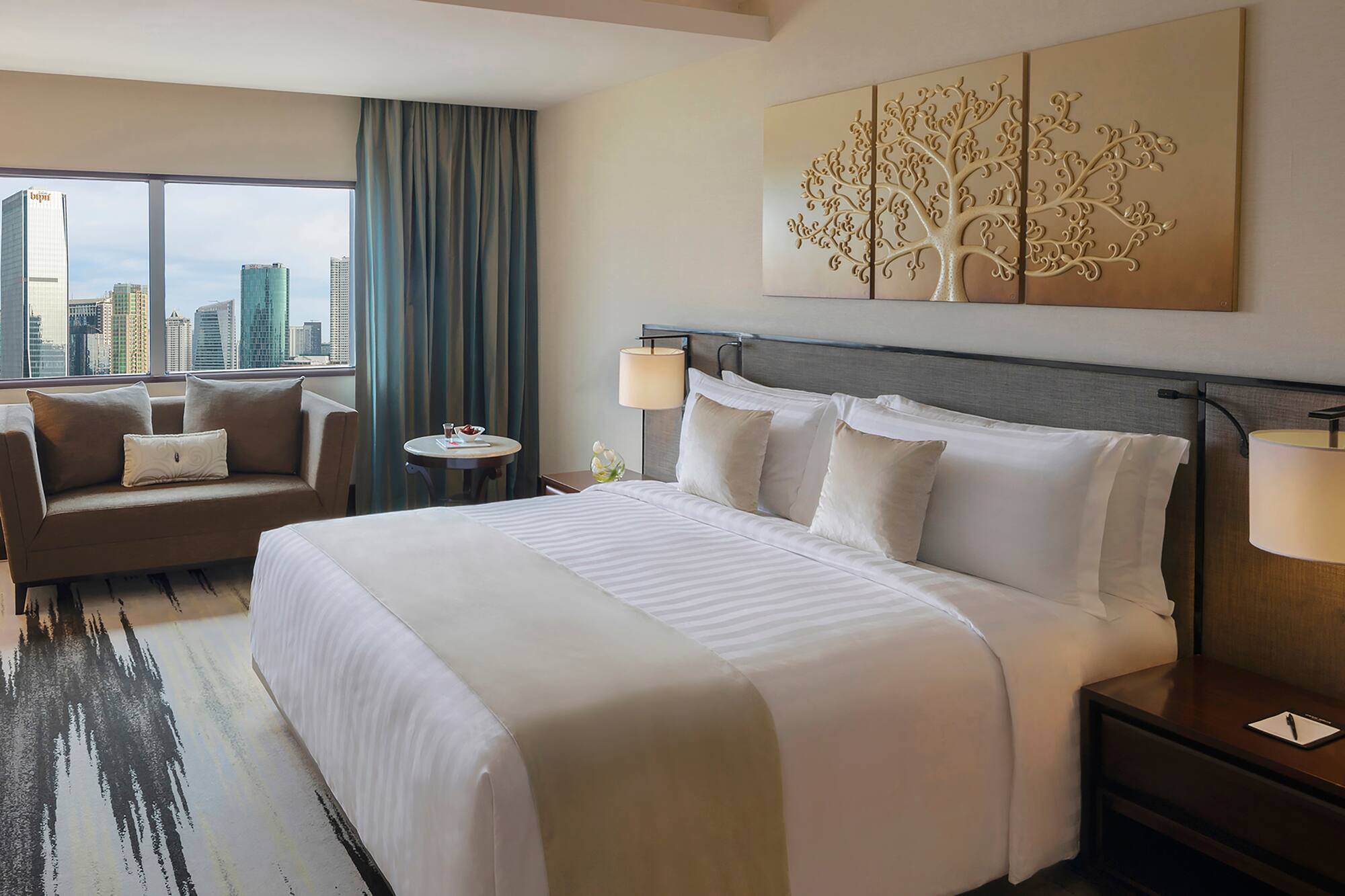 a hotel room with a bed and chairs