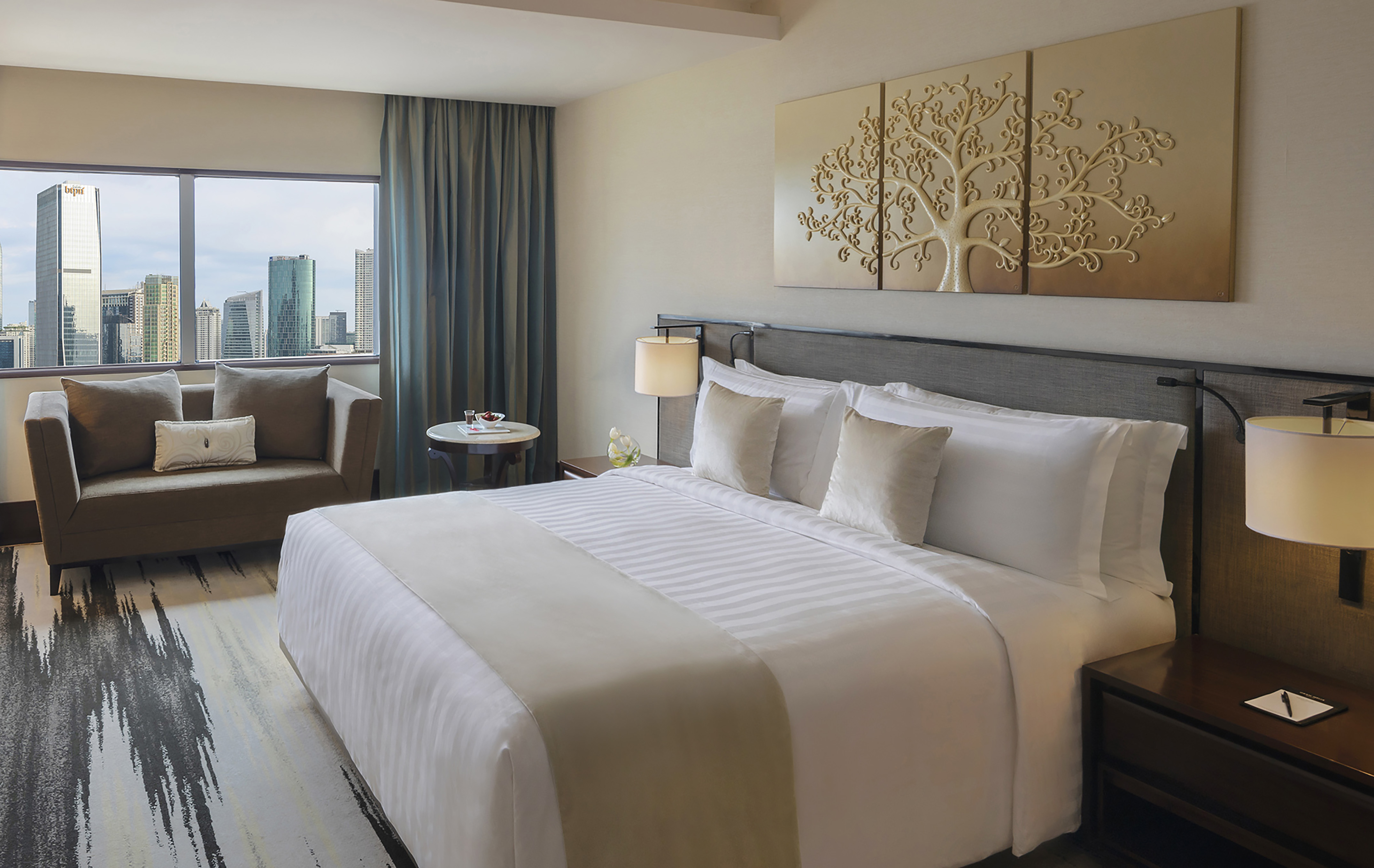 a hotel room with a bed and chairs