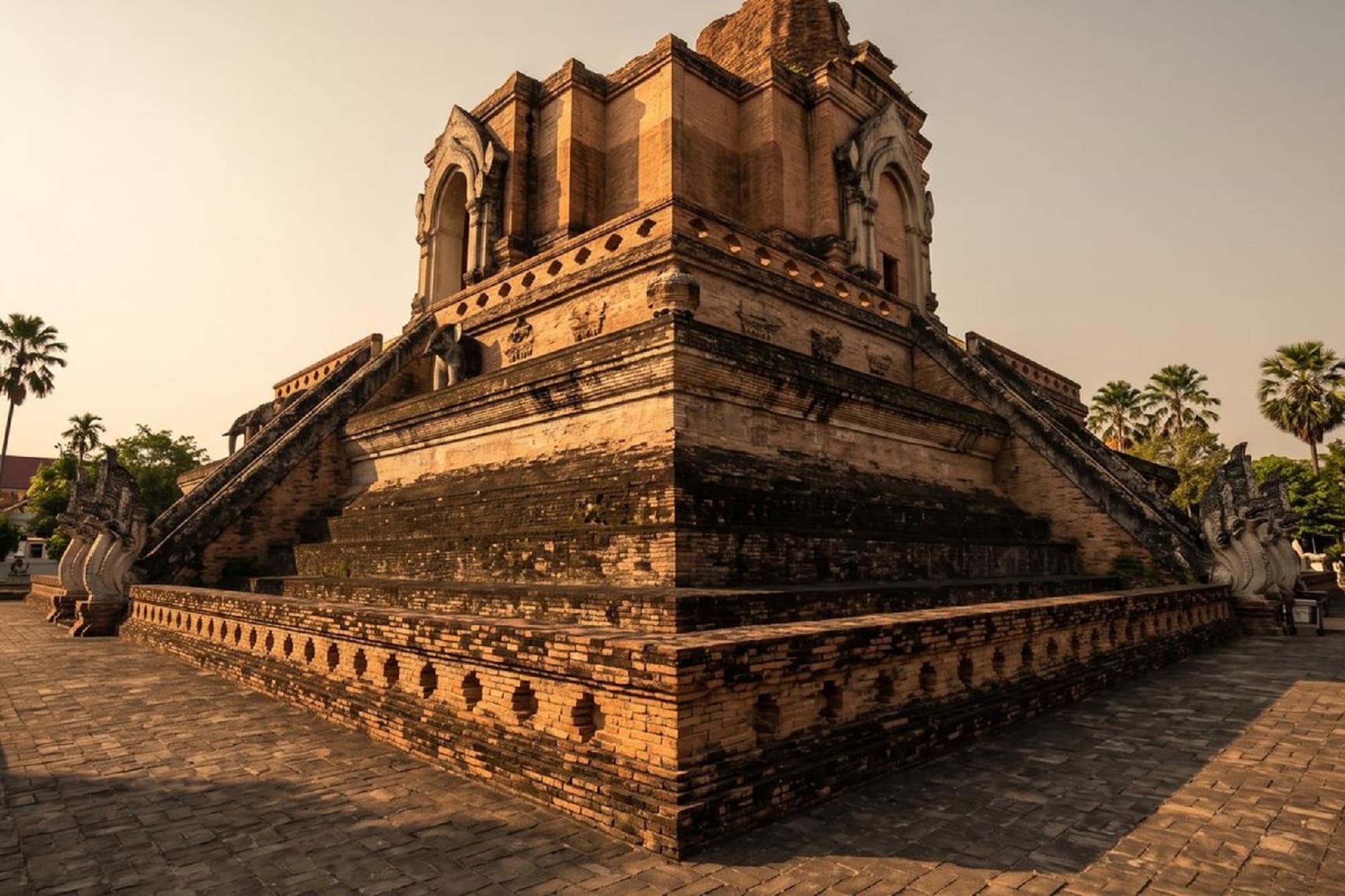 Ancient tiered brick temple with Naga stairs in Chiang Mai, Thailand.