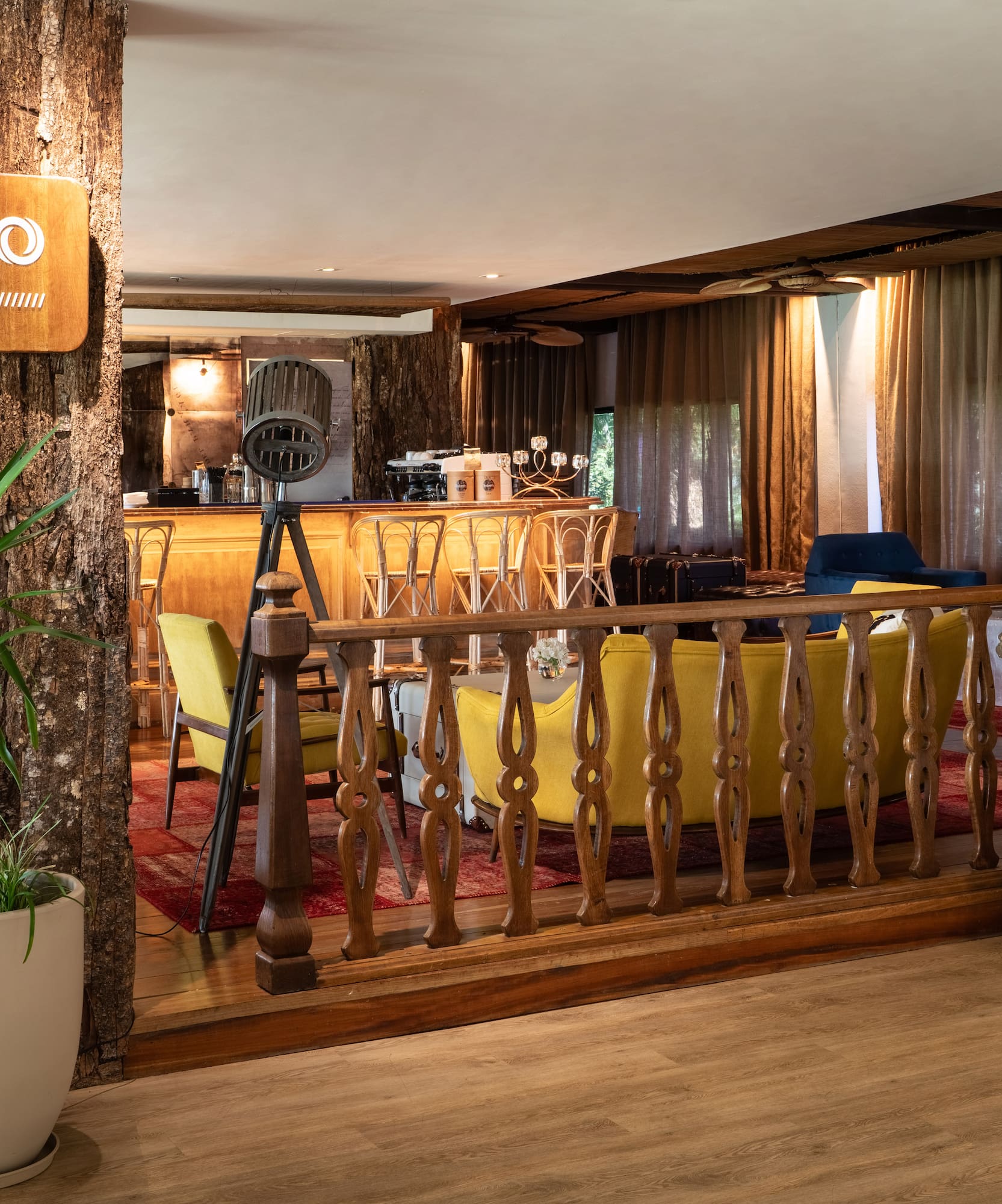 a room with a bar and a wood railing