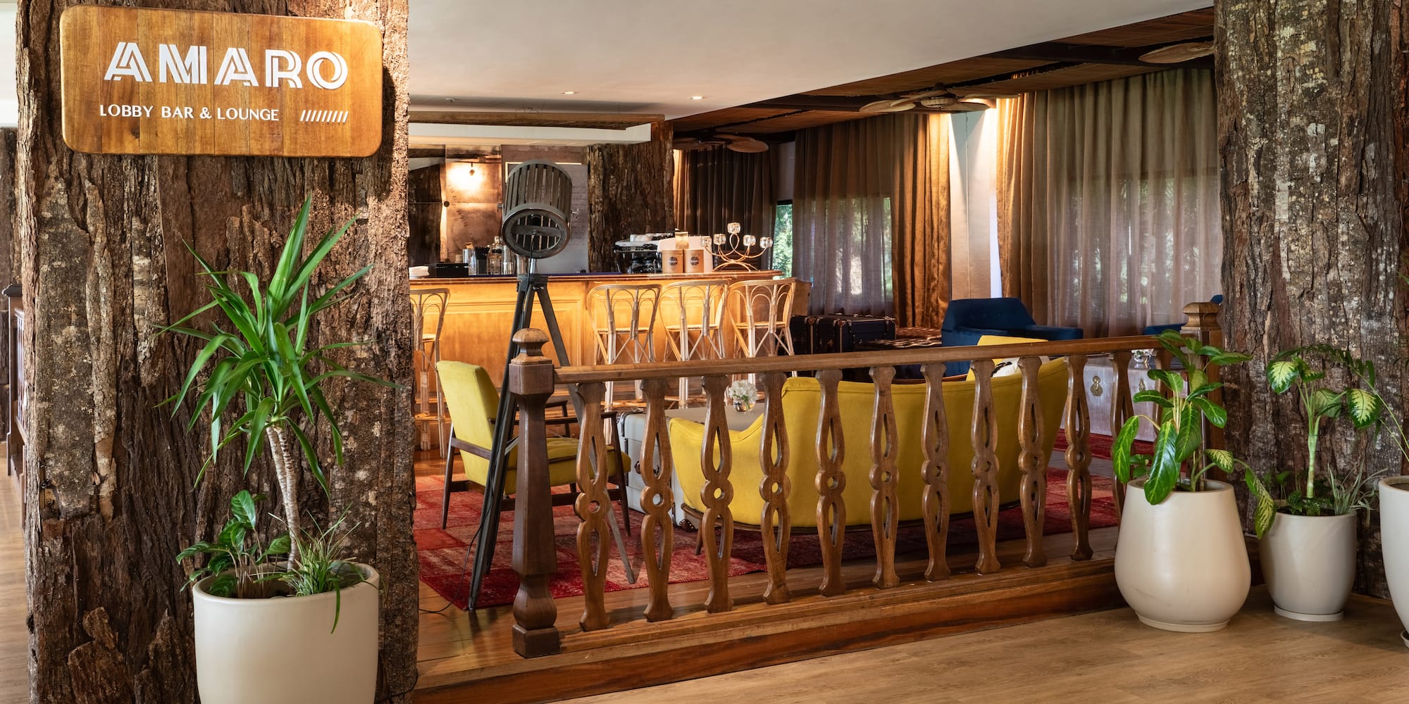 a room with a bar and a wood railing