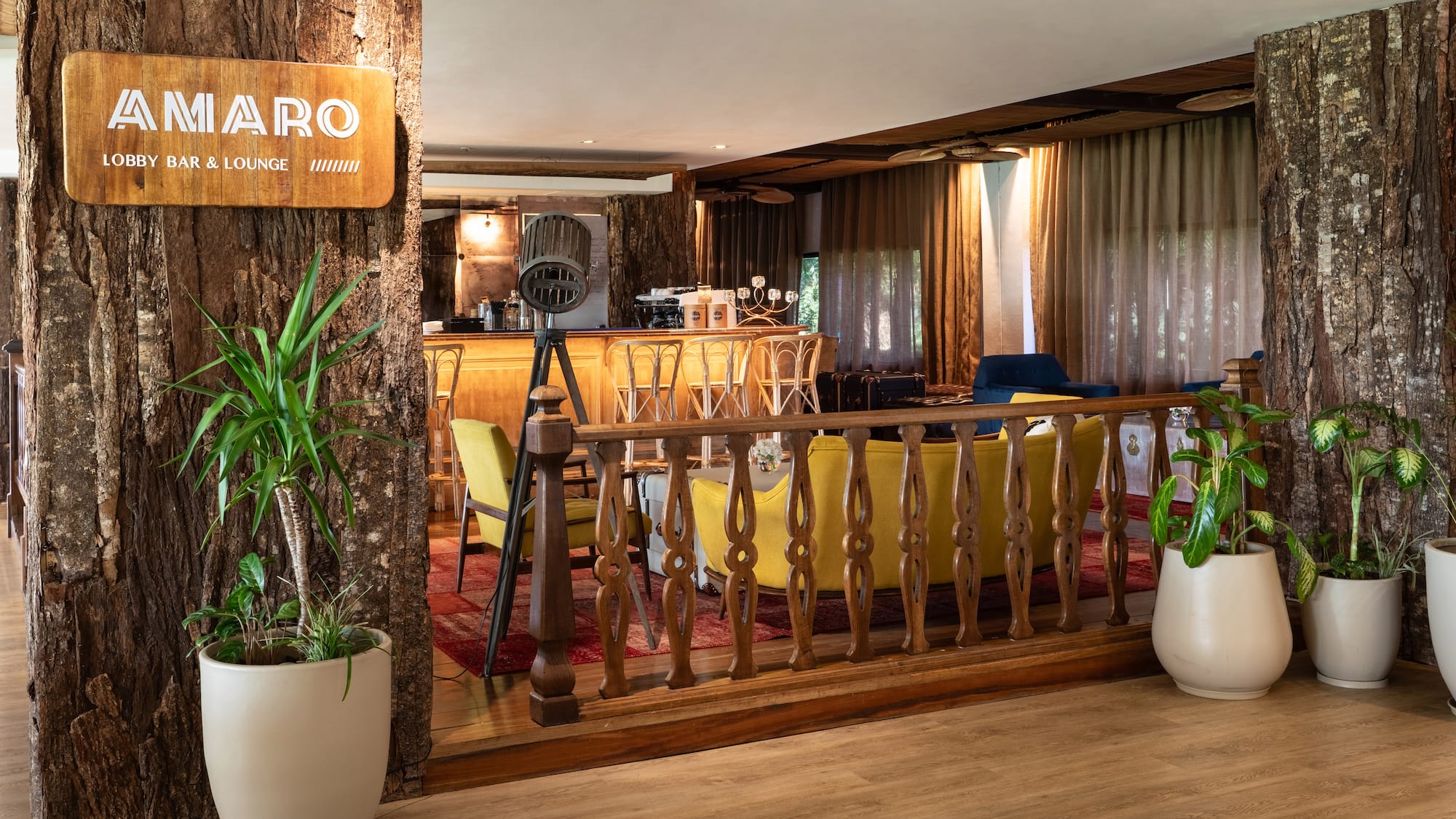 a room with a bar and a wood railing