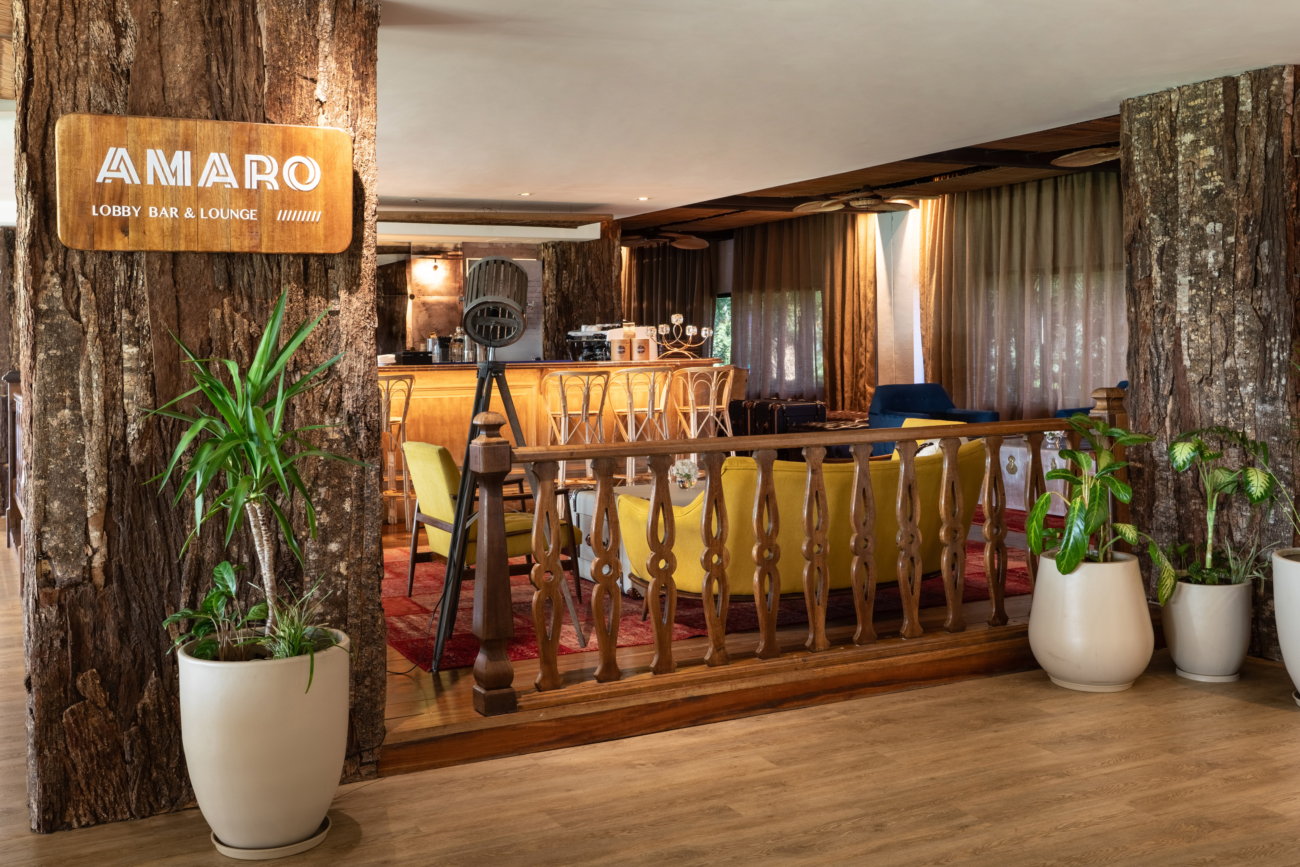Amaro Lobby Bar & Lounge interior, rustic wood, bar, and cozy seating.