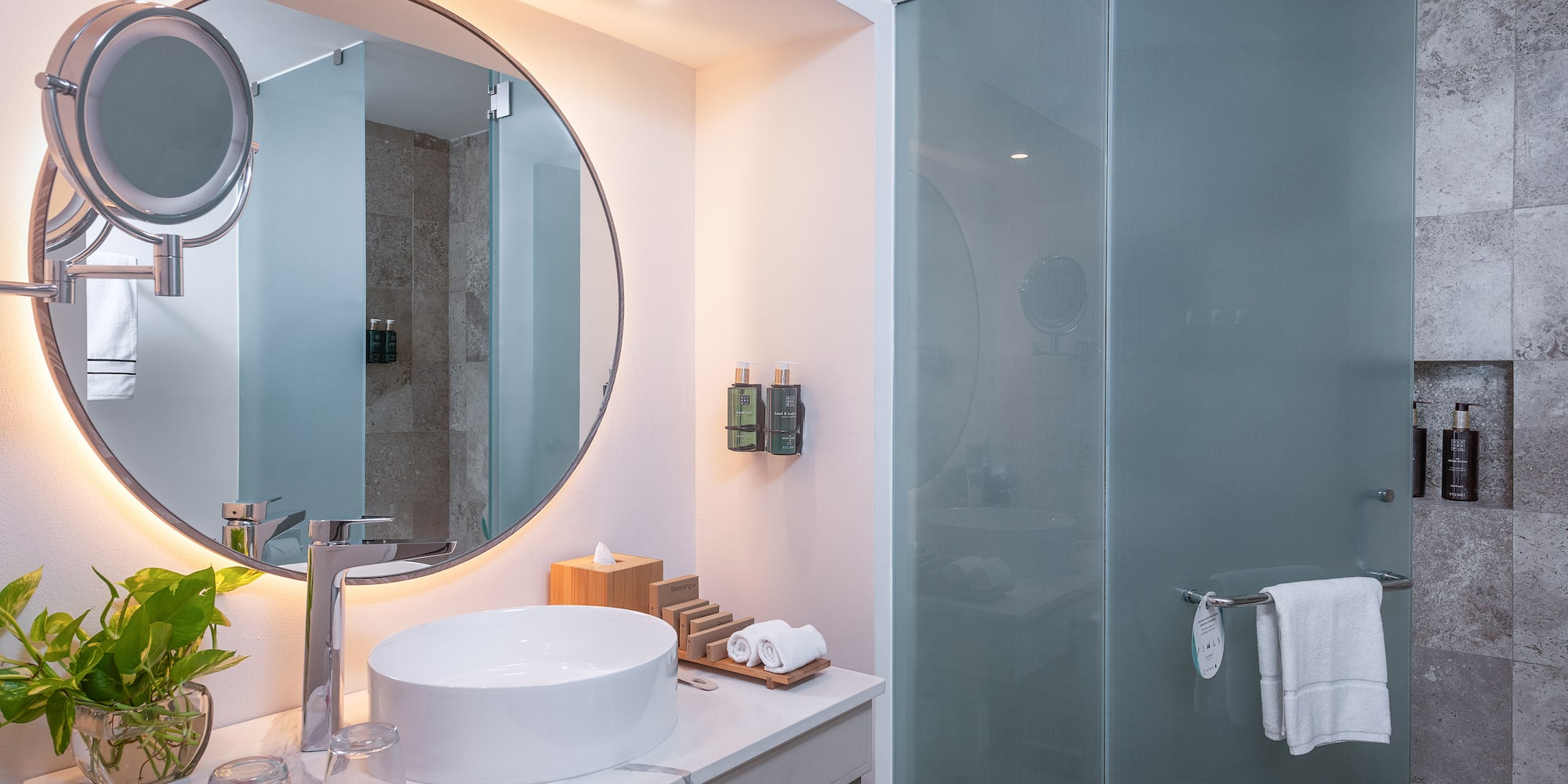 a bathroom with a round mirror