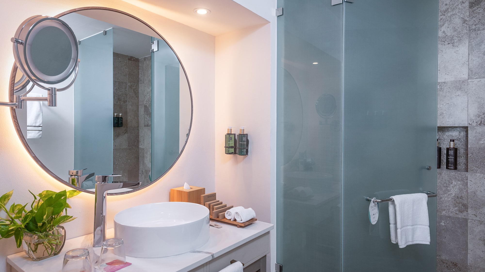 a bathroom with a round mirror