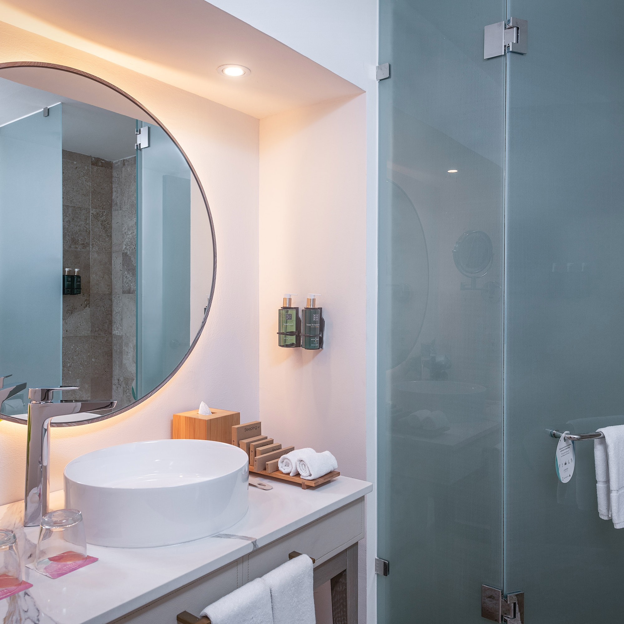 a bathroom with a round mirror