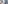 Modern bathroom with backlit mirror, vessel sink, and frosted glass shower.