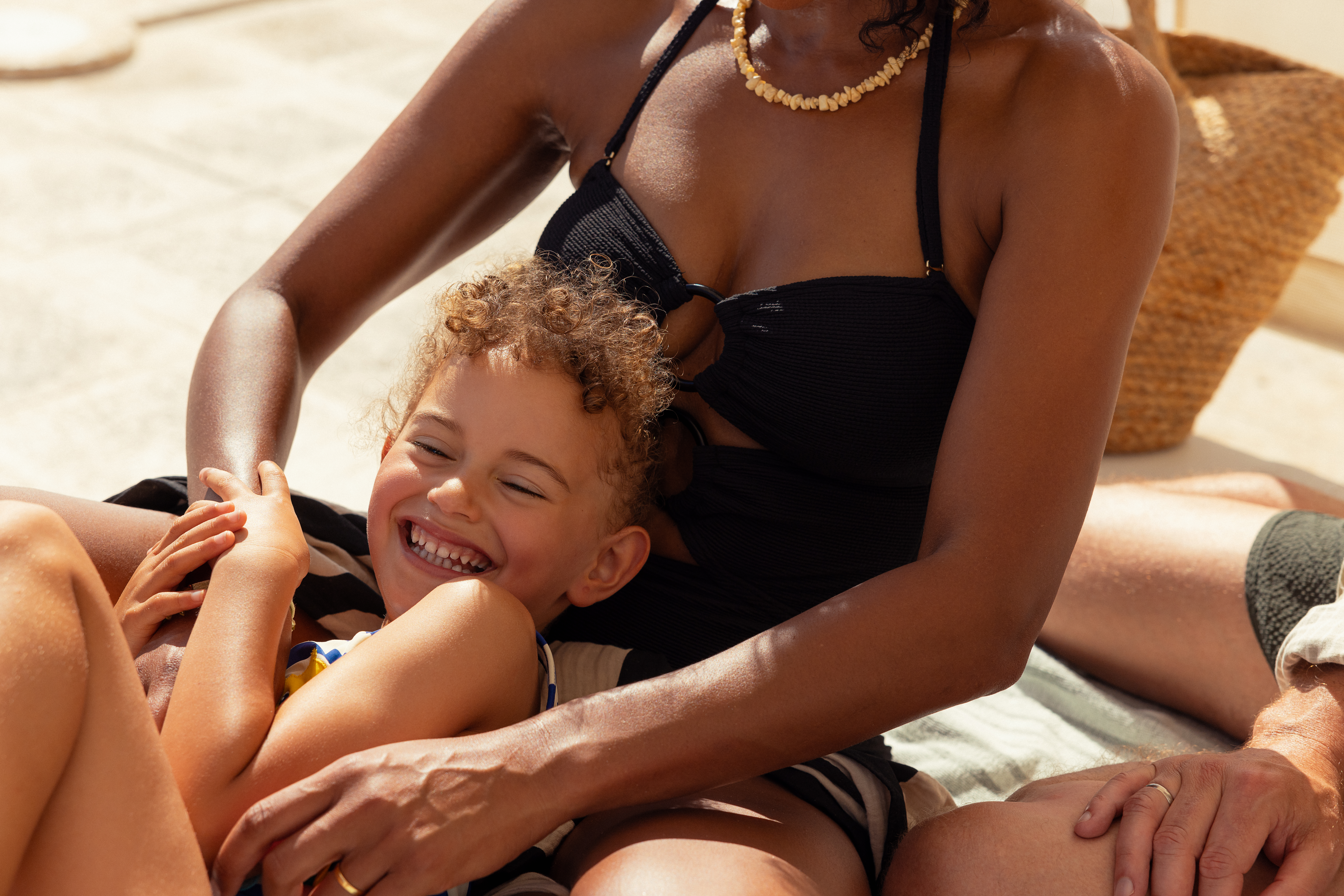 a woman and child sitting on a blanket