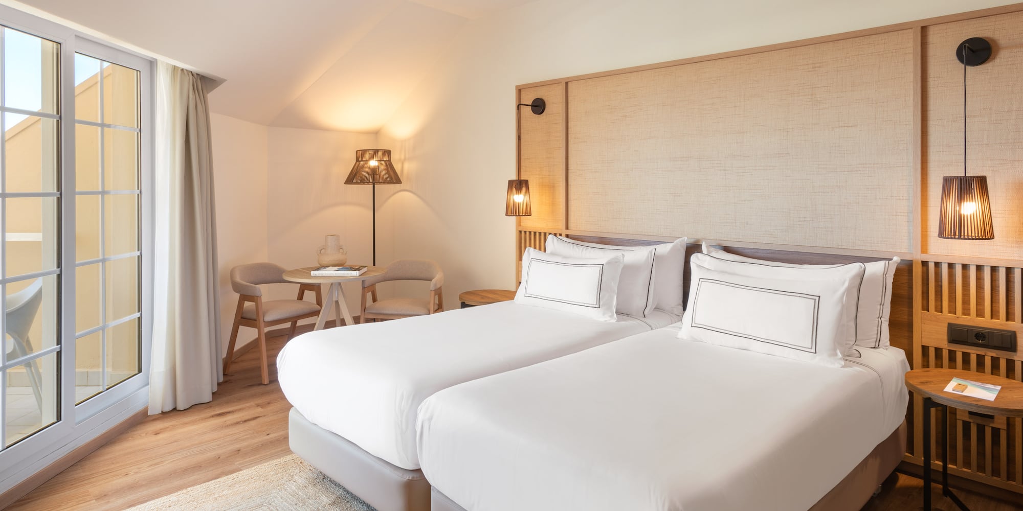 a room with two beds and a table