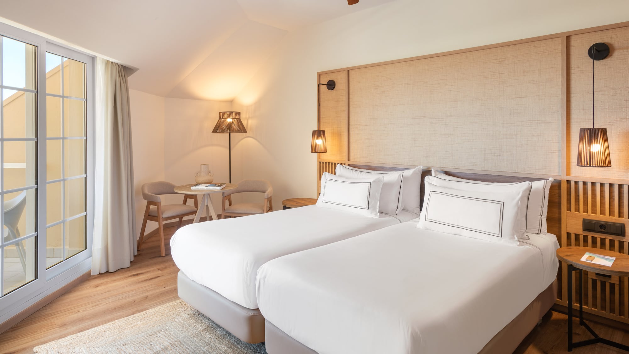 a room with two beds and a table