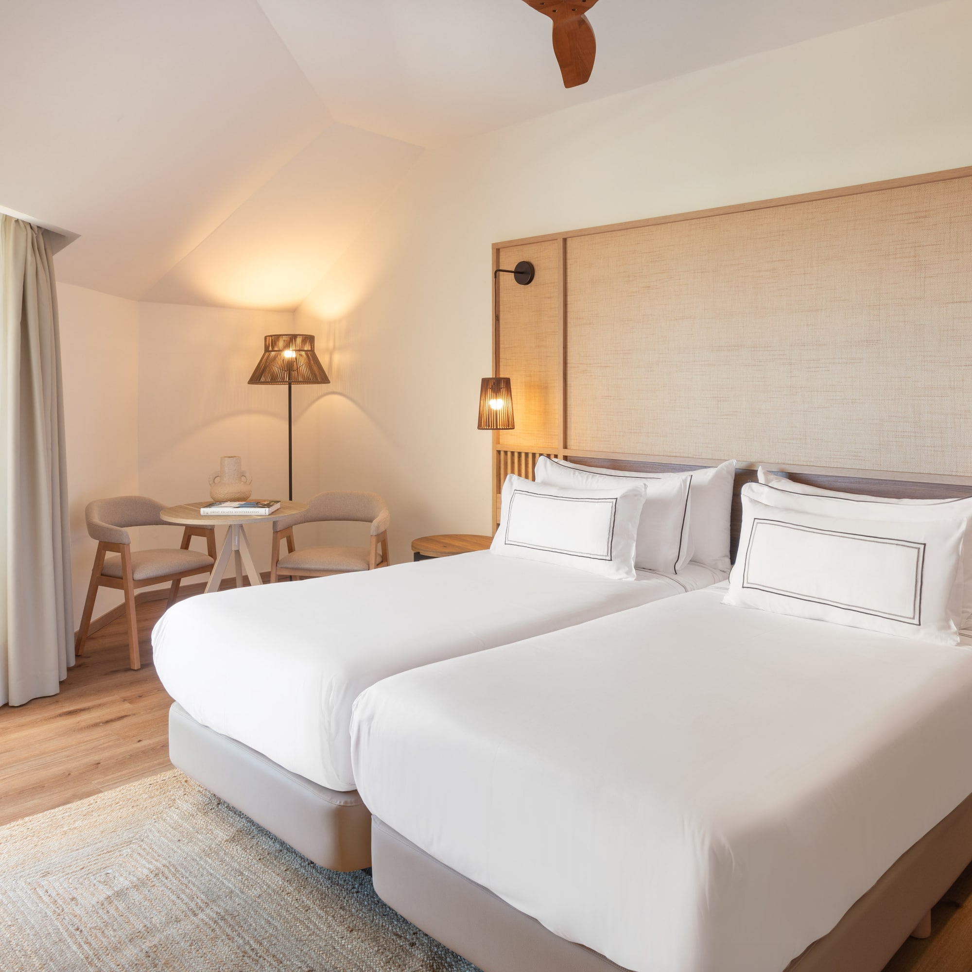 a room with two beds and a table