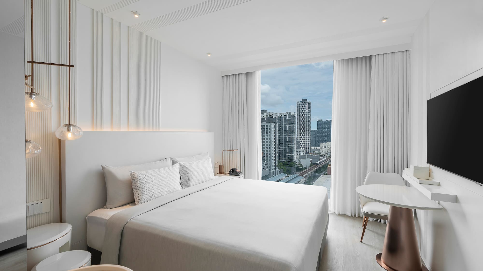 a bedroom with a large window and a city view