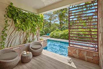 a pool with a chair and a table