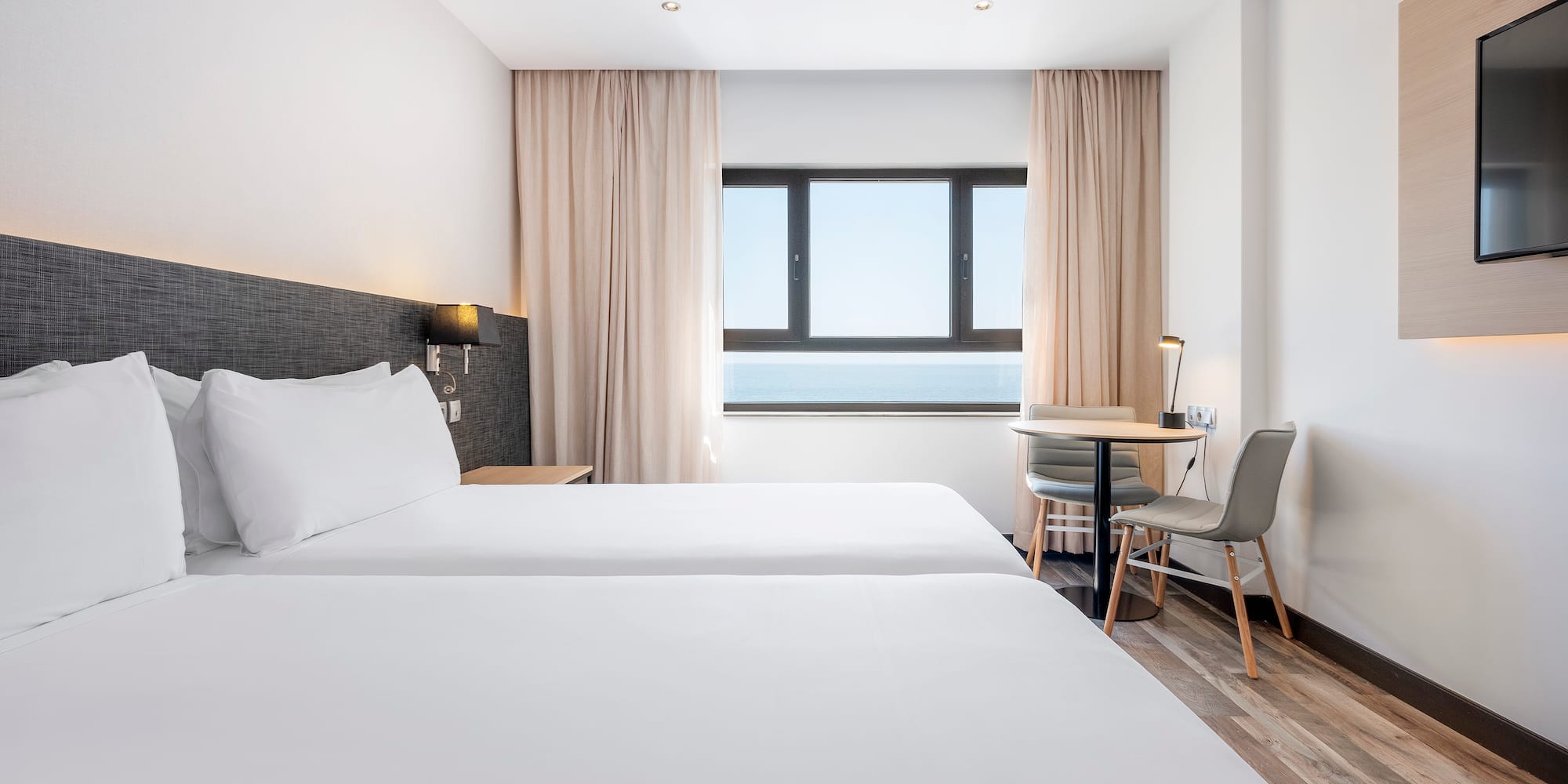 a room with two beds and a table