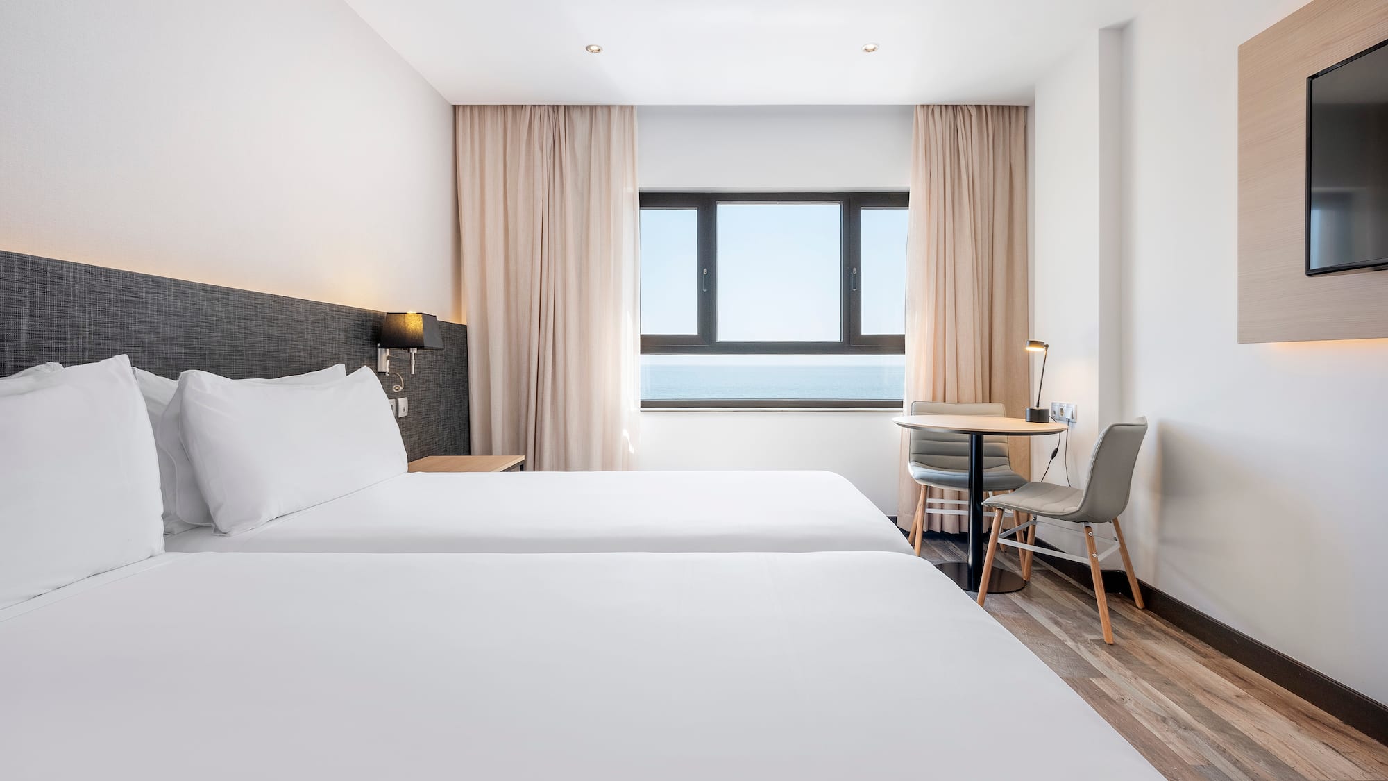 a room with two beds and a table