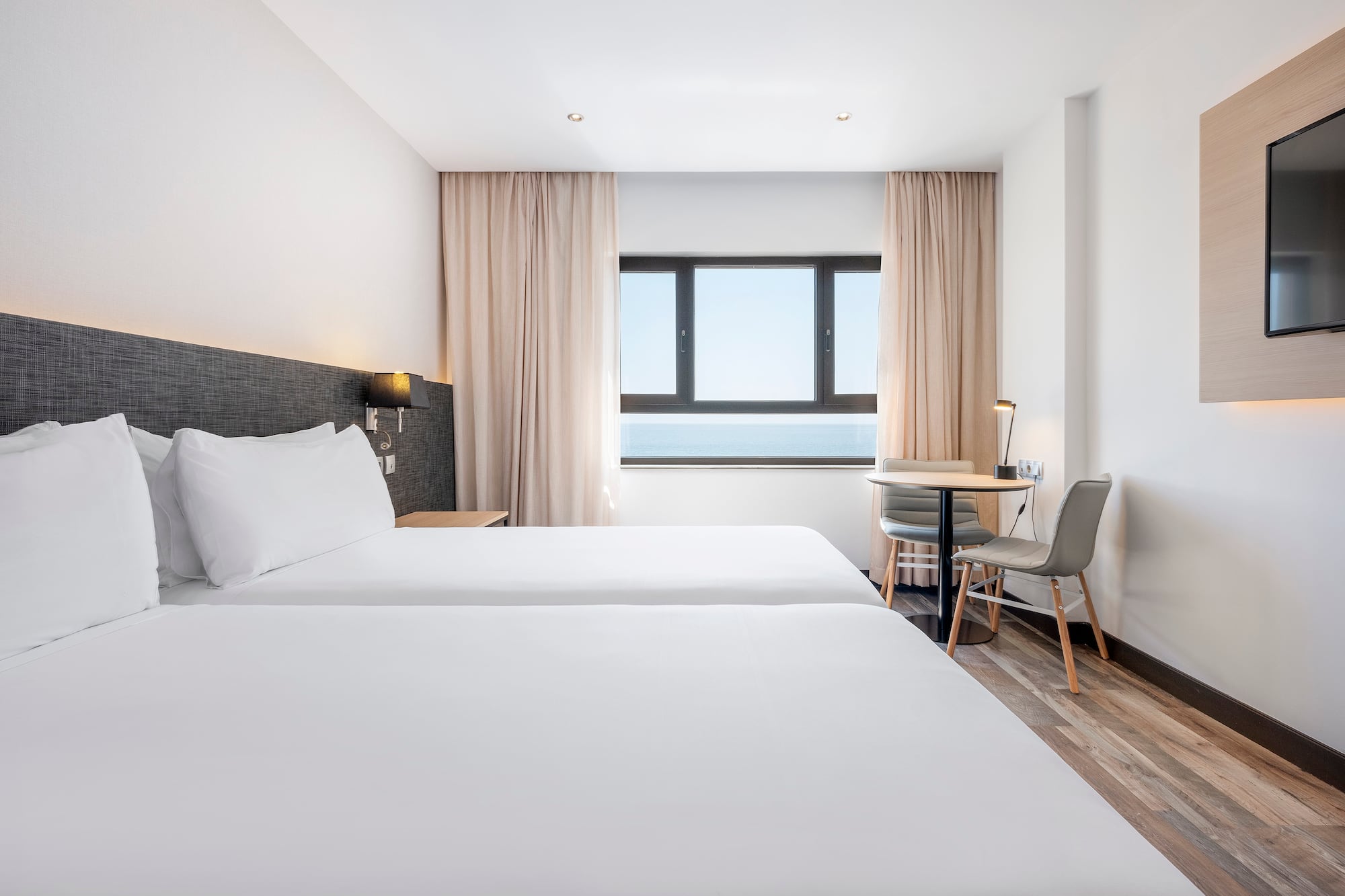 a room with two beds and a table