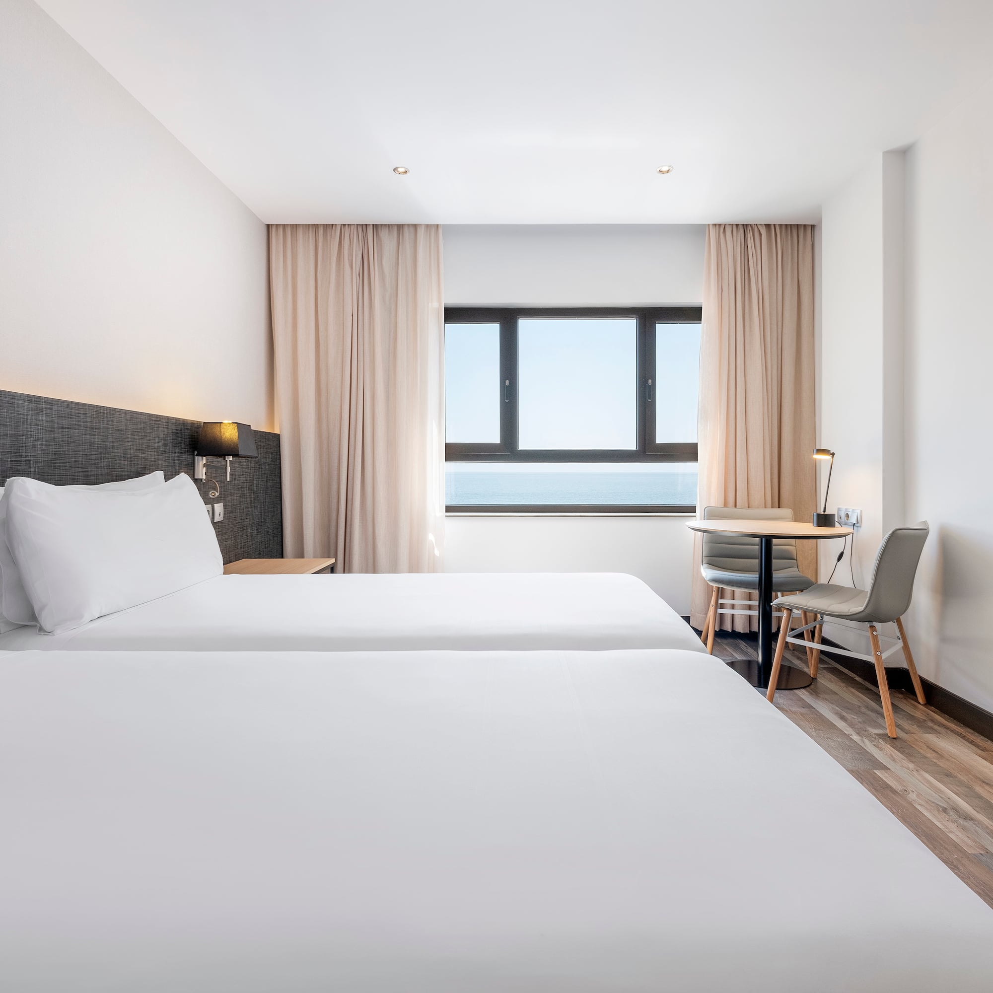 a room with two beds and a table