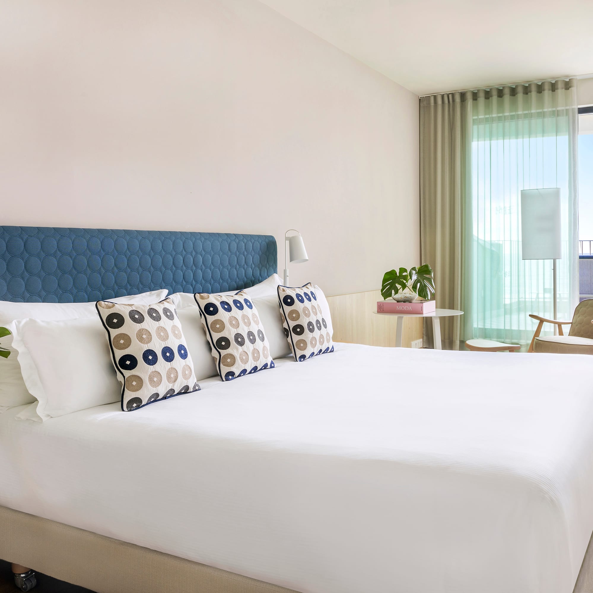 a bed with pillows in a room