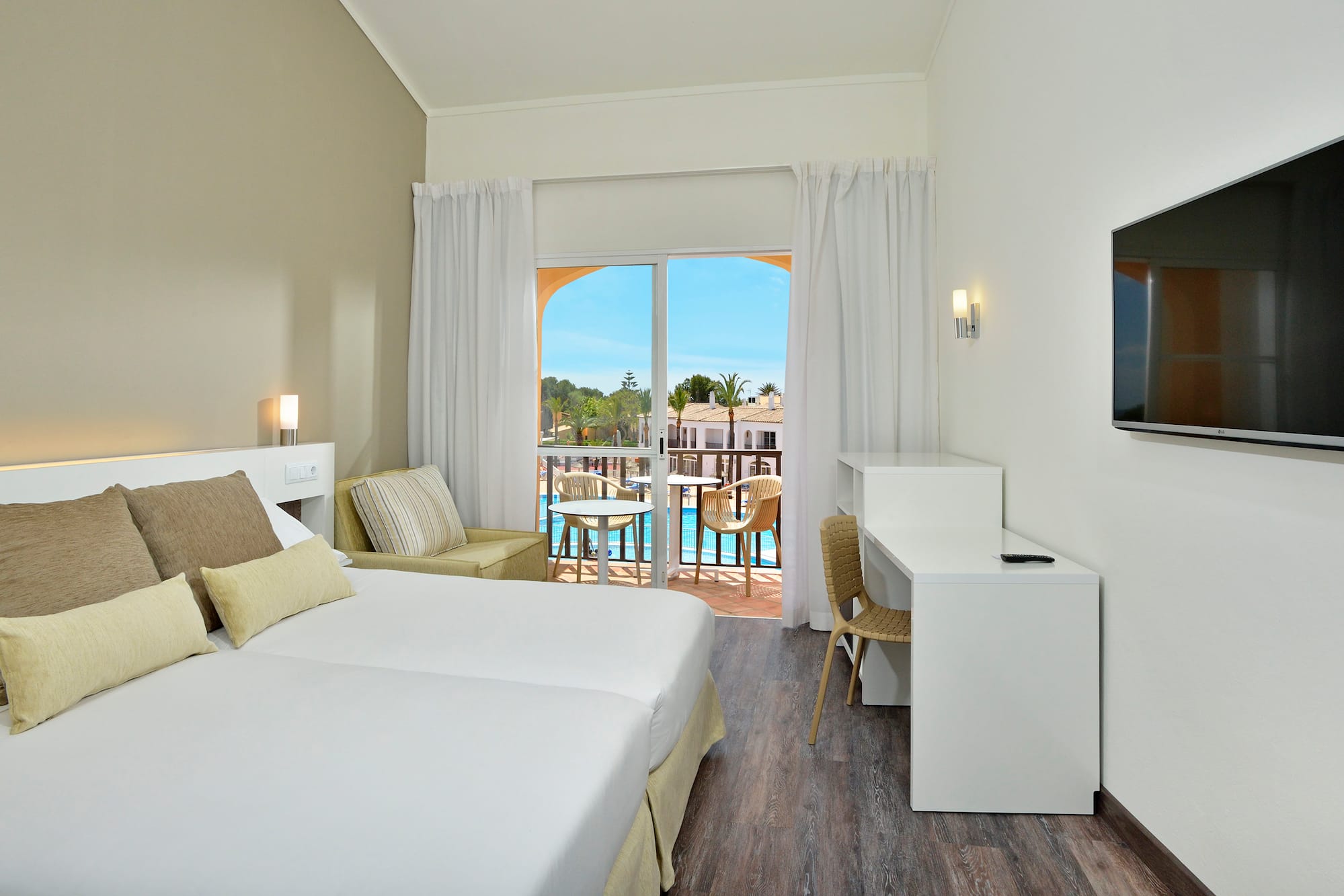 a room with two beds and a television