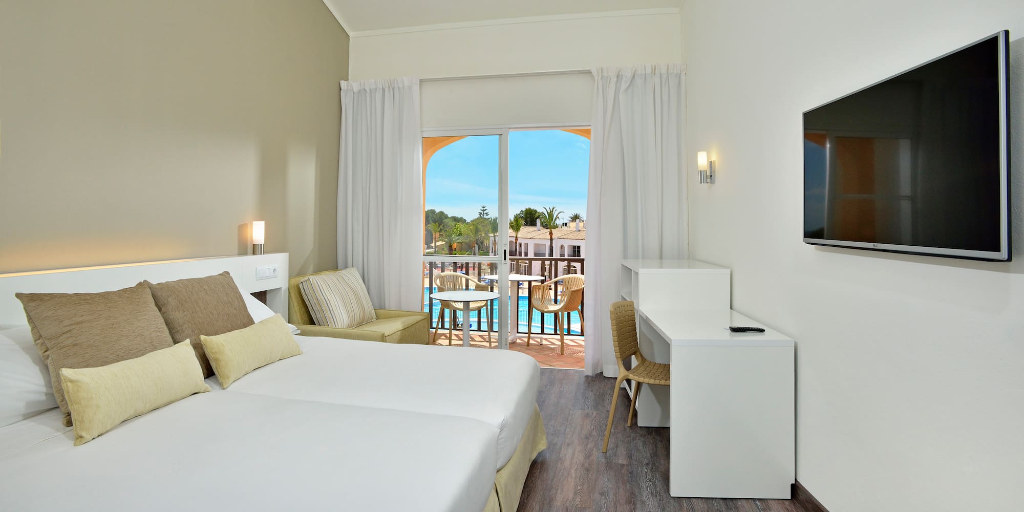 a room with two beds and a television