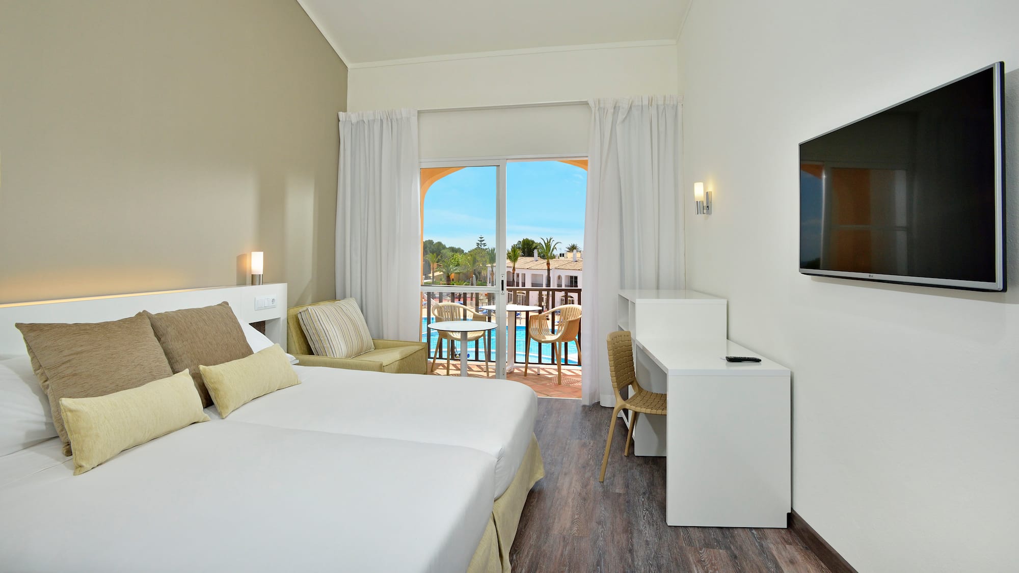 a room with two beds and a television