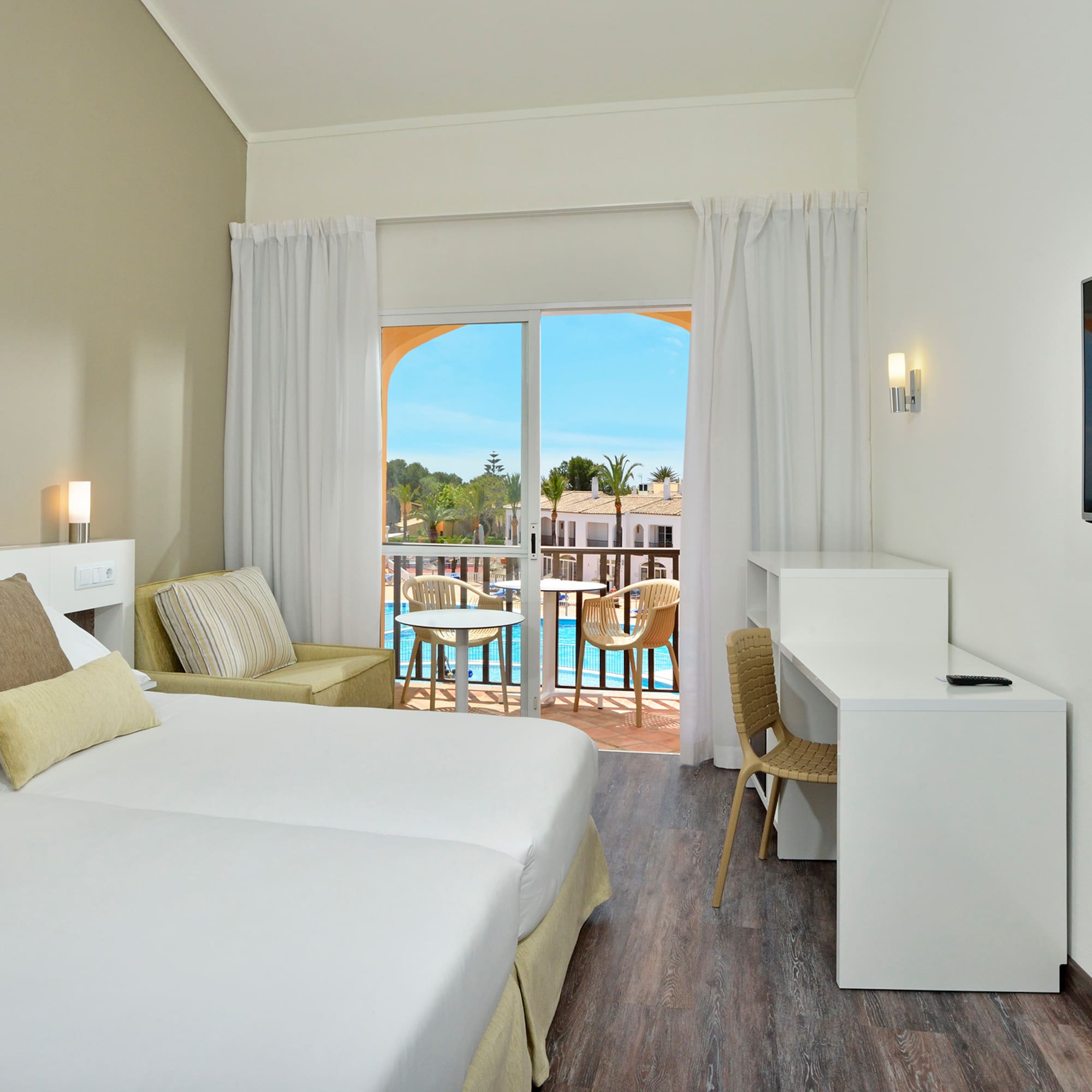 a room with two beds and a television