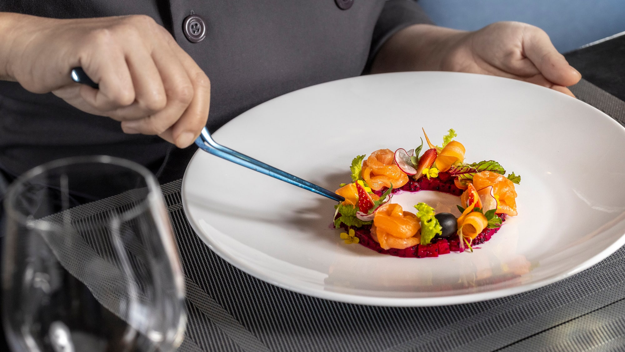 a person holding a fork over a plate of food