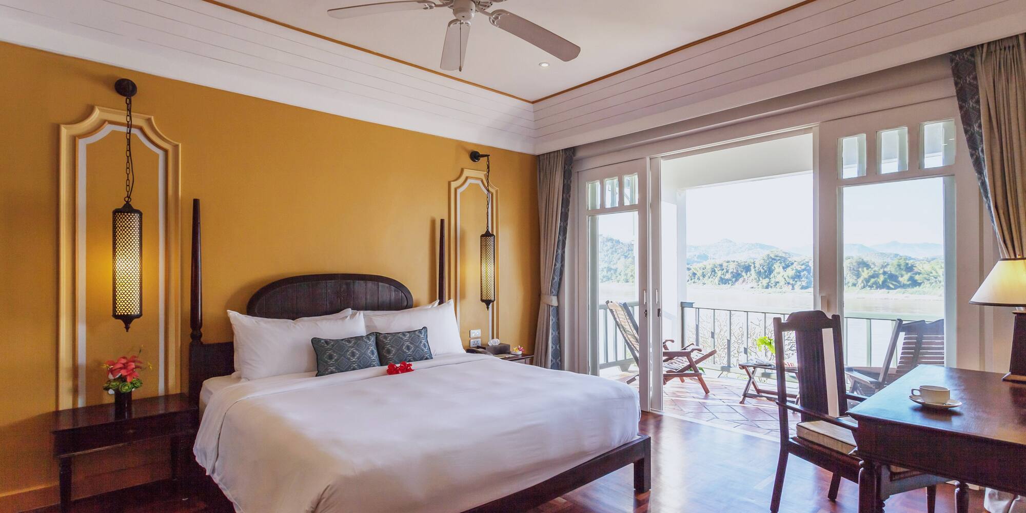 a room with a bed and a ceiling fan