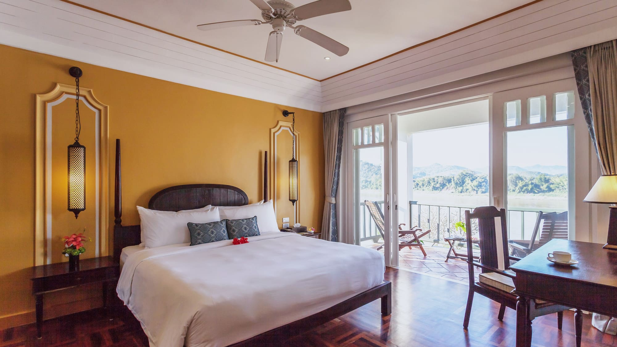 a room with a bed and a ceiling fan