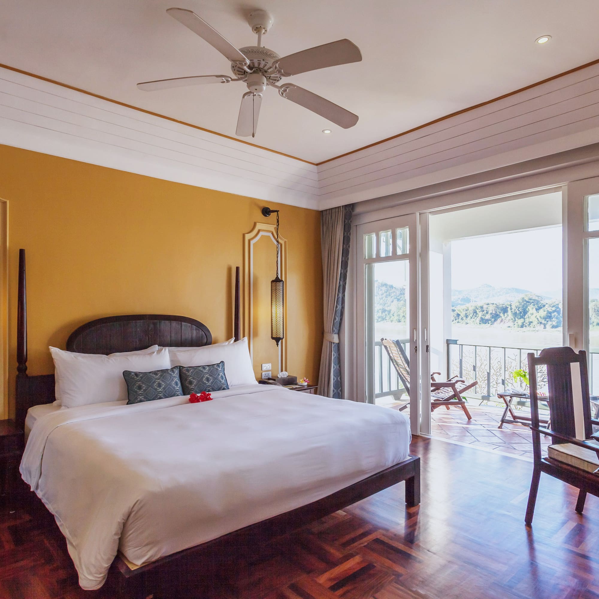 a room with a bed and a ceiling fan