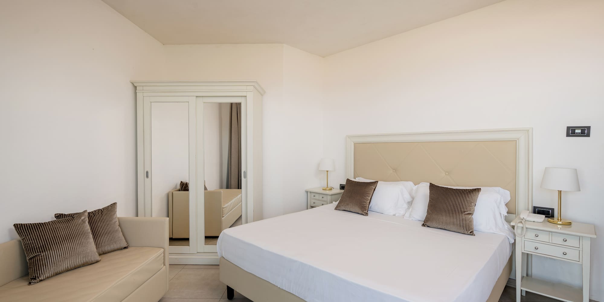 a bedroom with a bed and a mirror