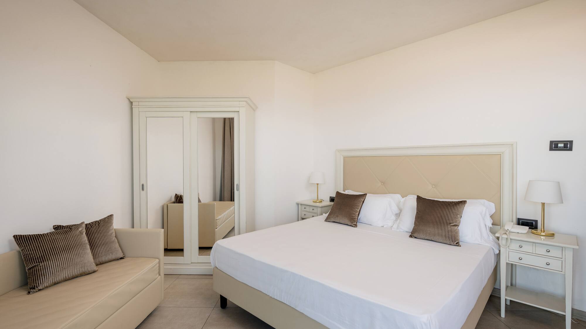 a bedroom with a bed and a mirror