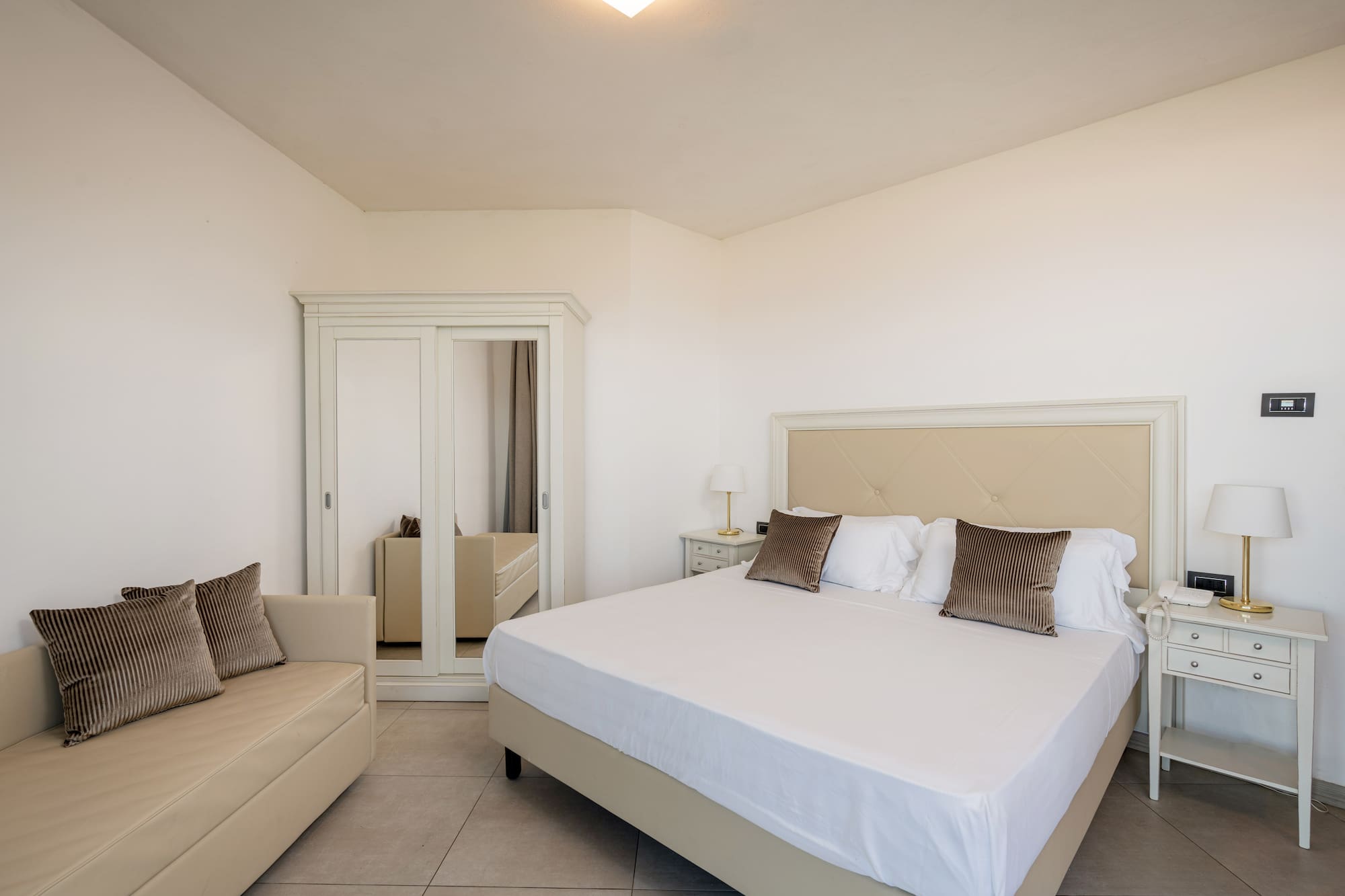 a bedroom with a bed and a mirror