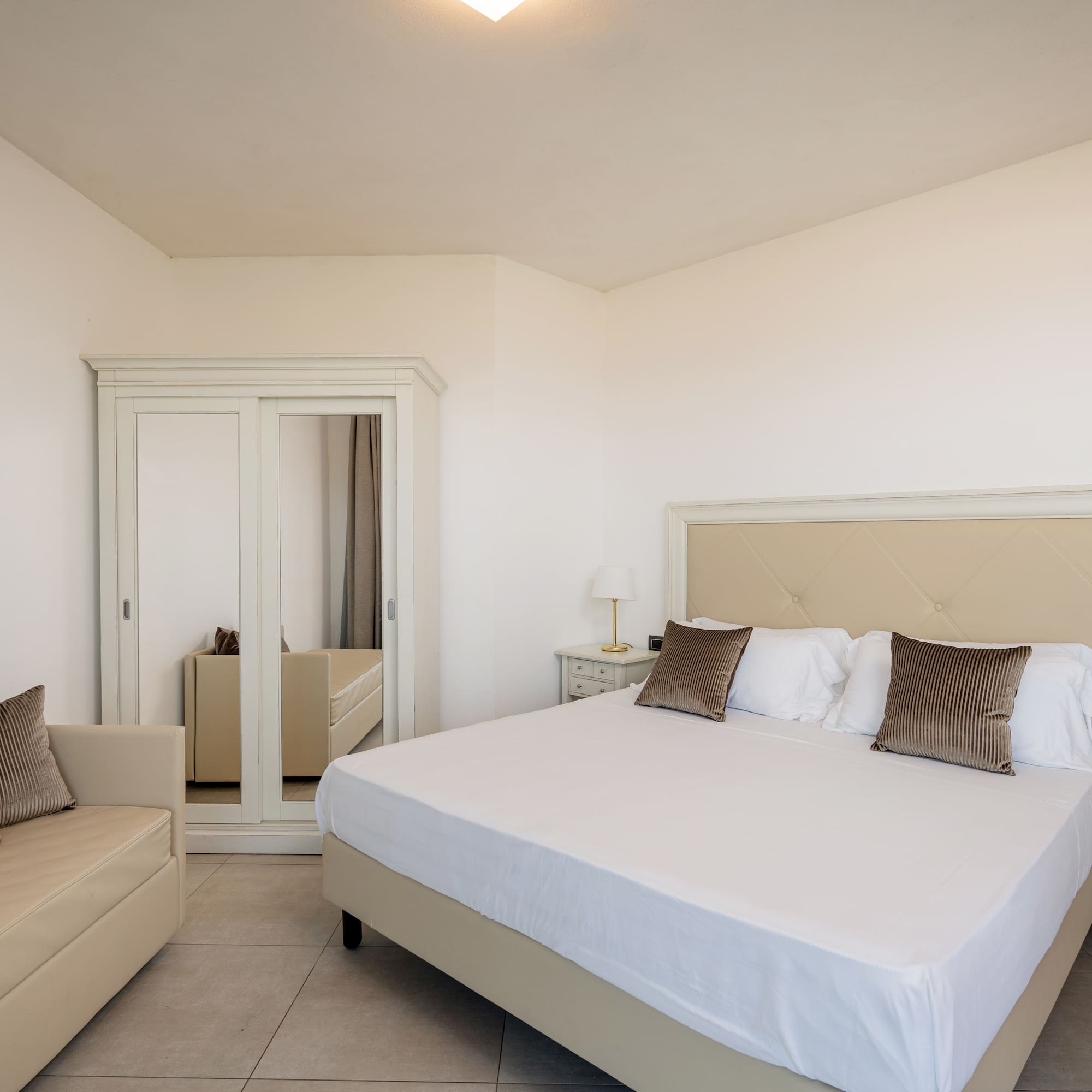 a bedroom with a bed and a mirror