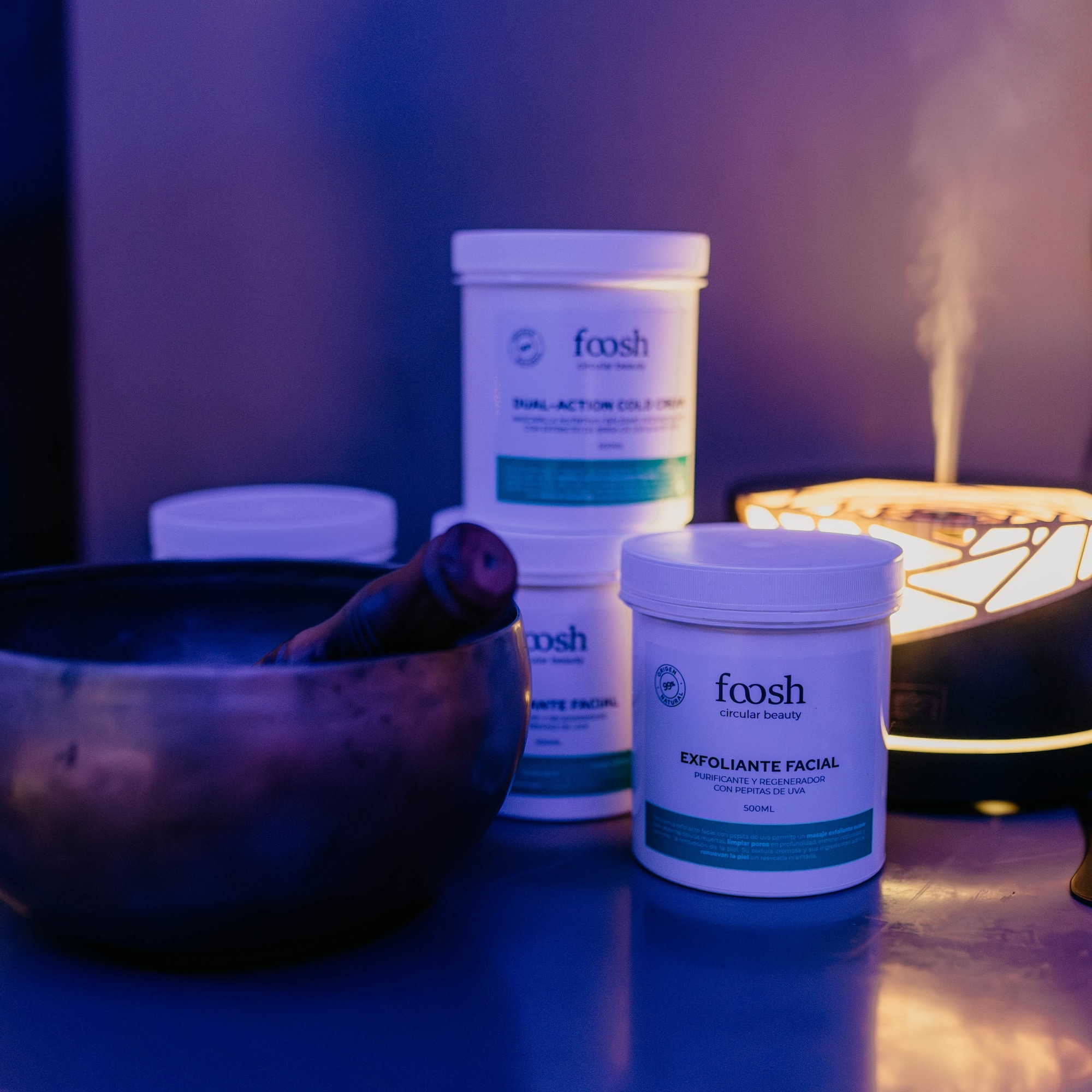 White Foosh Exfoliante Facial jar, spa diffuser, and singing bowl.