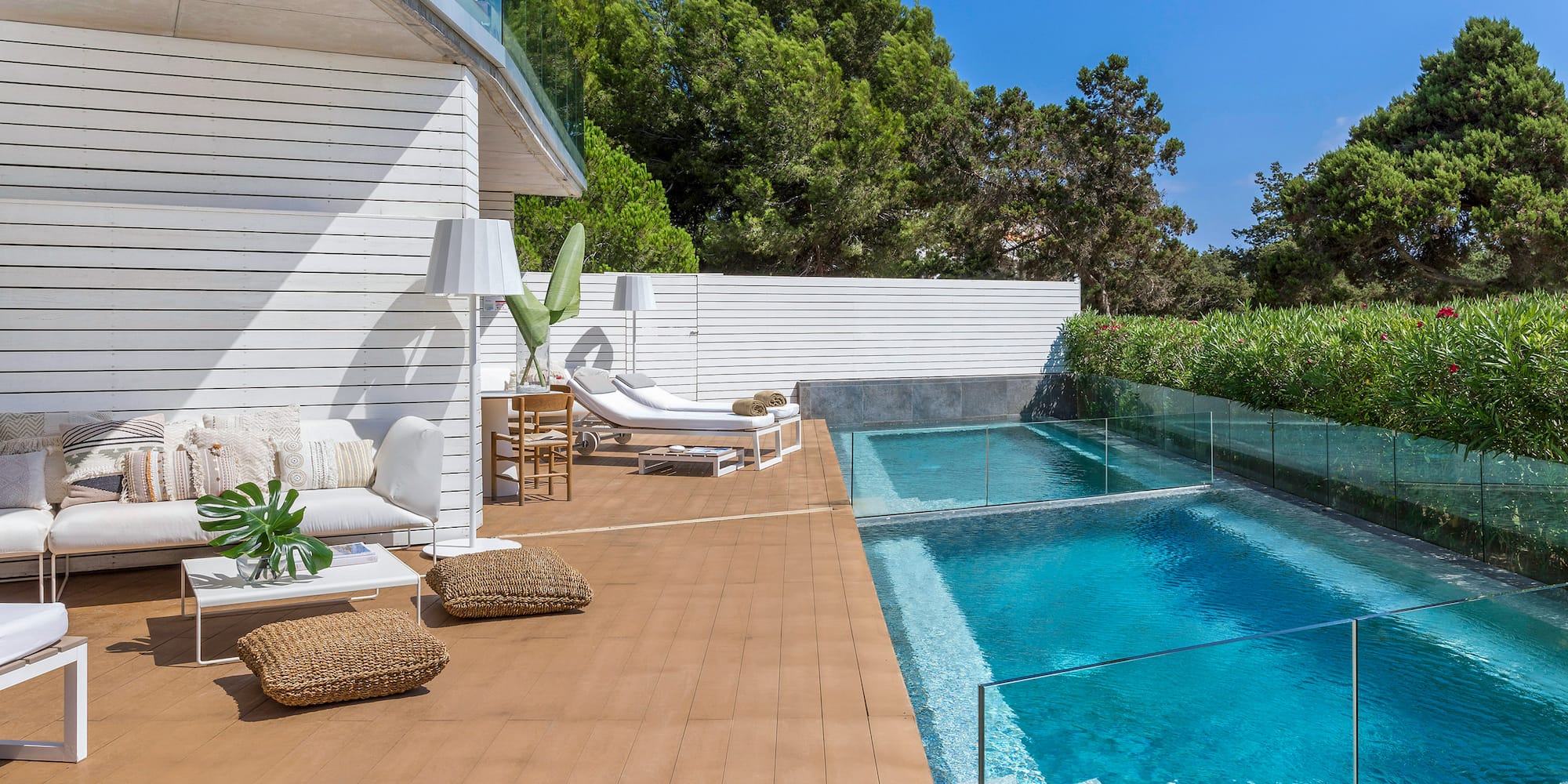a swimming pool and a deck with chairs