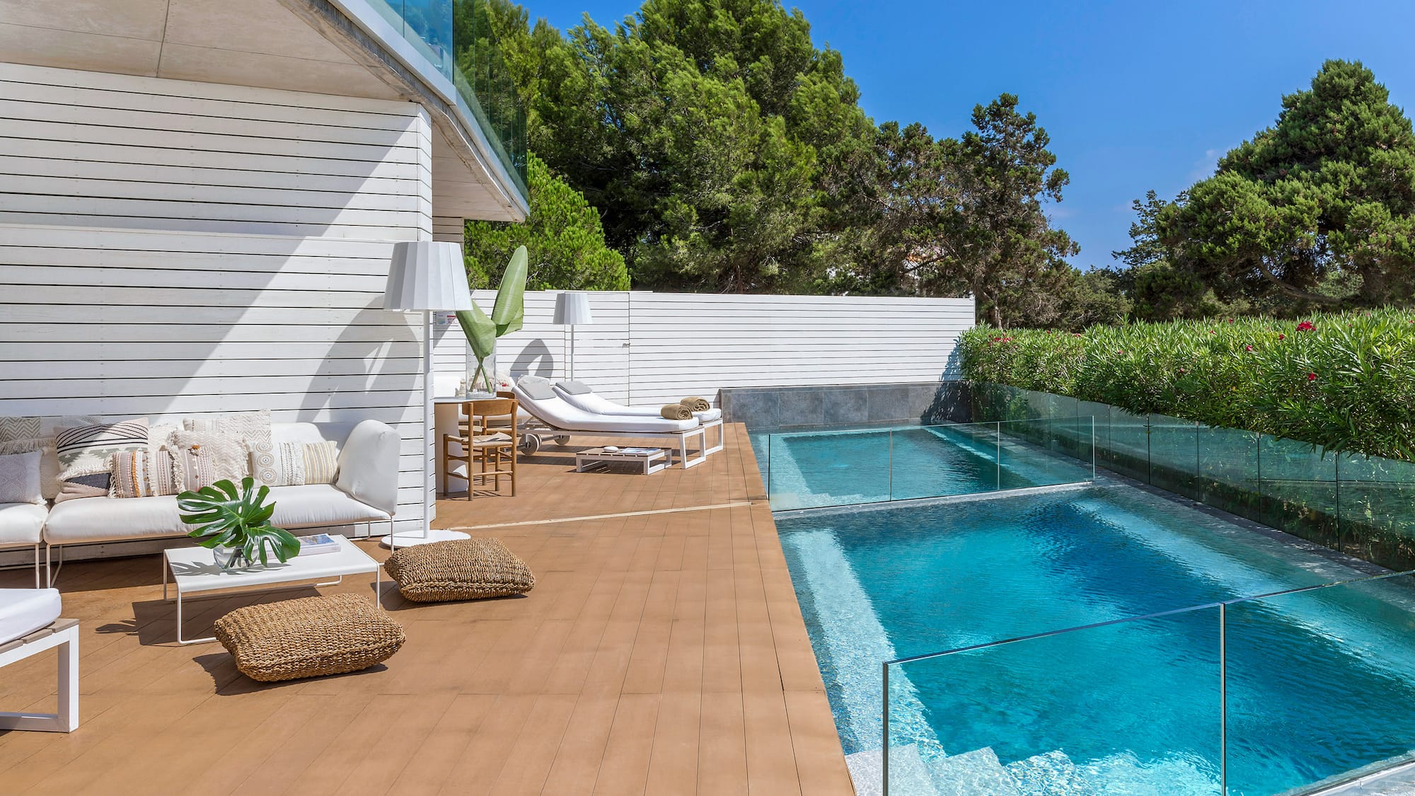 a swimming pool and a deck with chairs