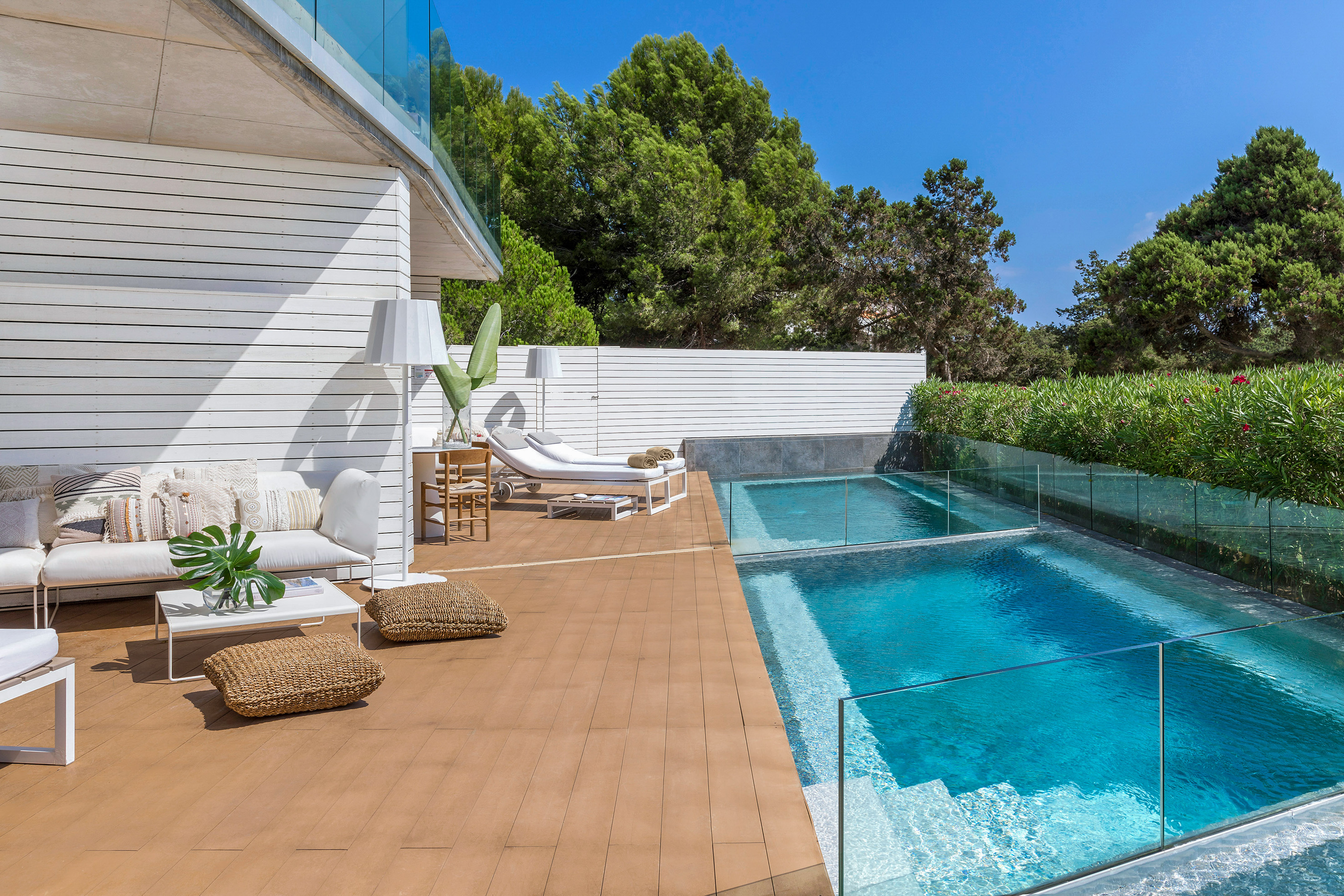 a swimming pool and a deck with chairs