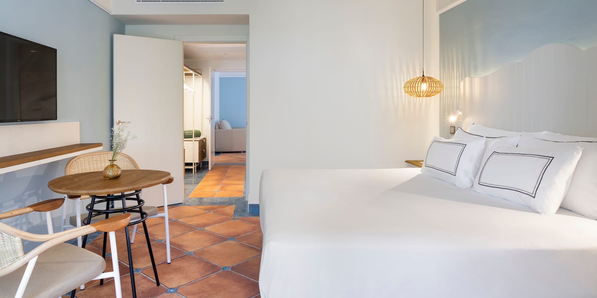 a bedroom with a table and chairs