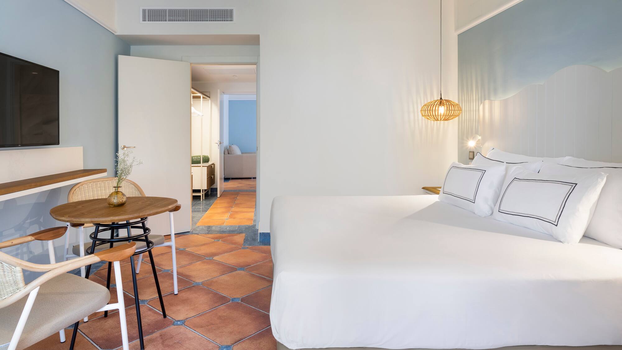 a bedroom with a table and chairs