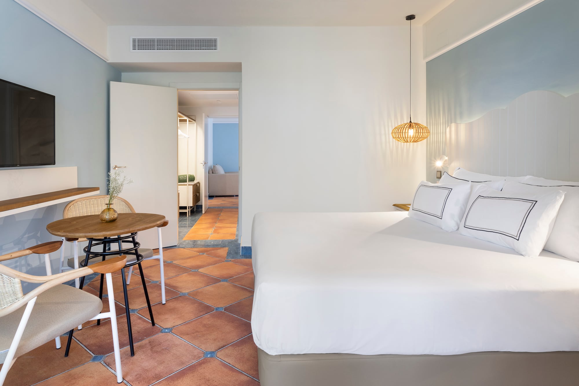 a bedroom with a table and chairs