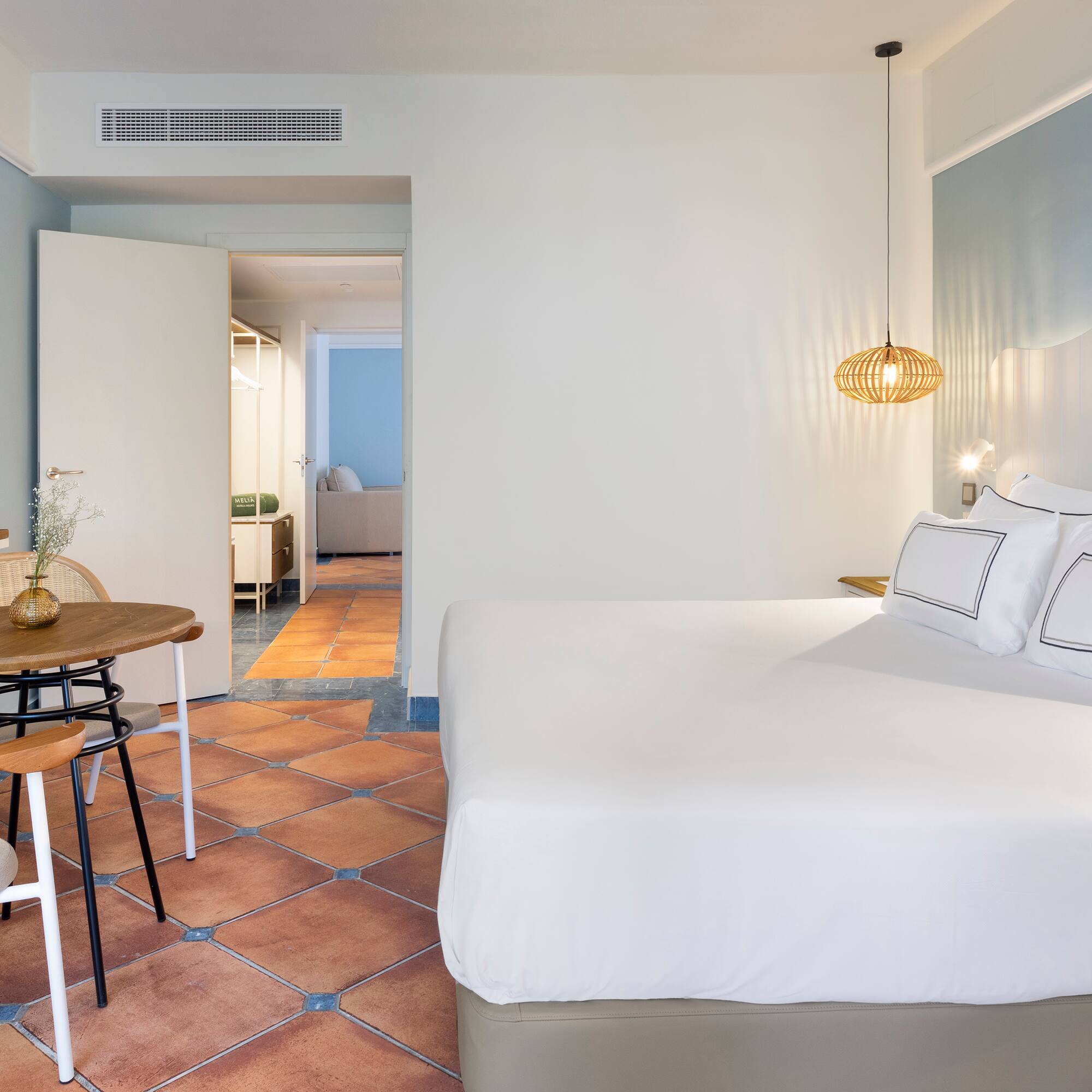 a bedroom with a table and chairs