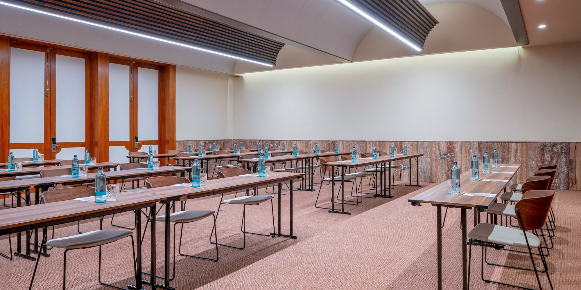 a room with tables and chairs and water bottles