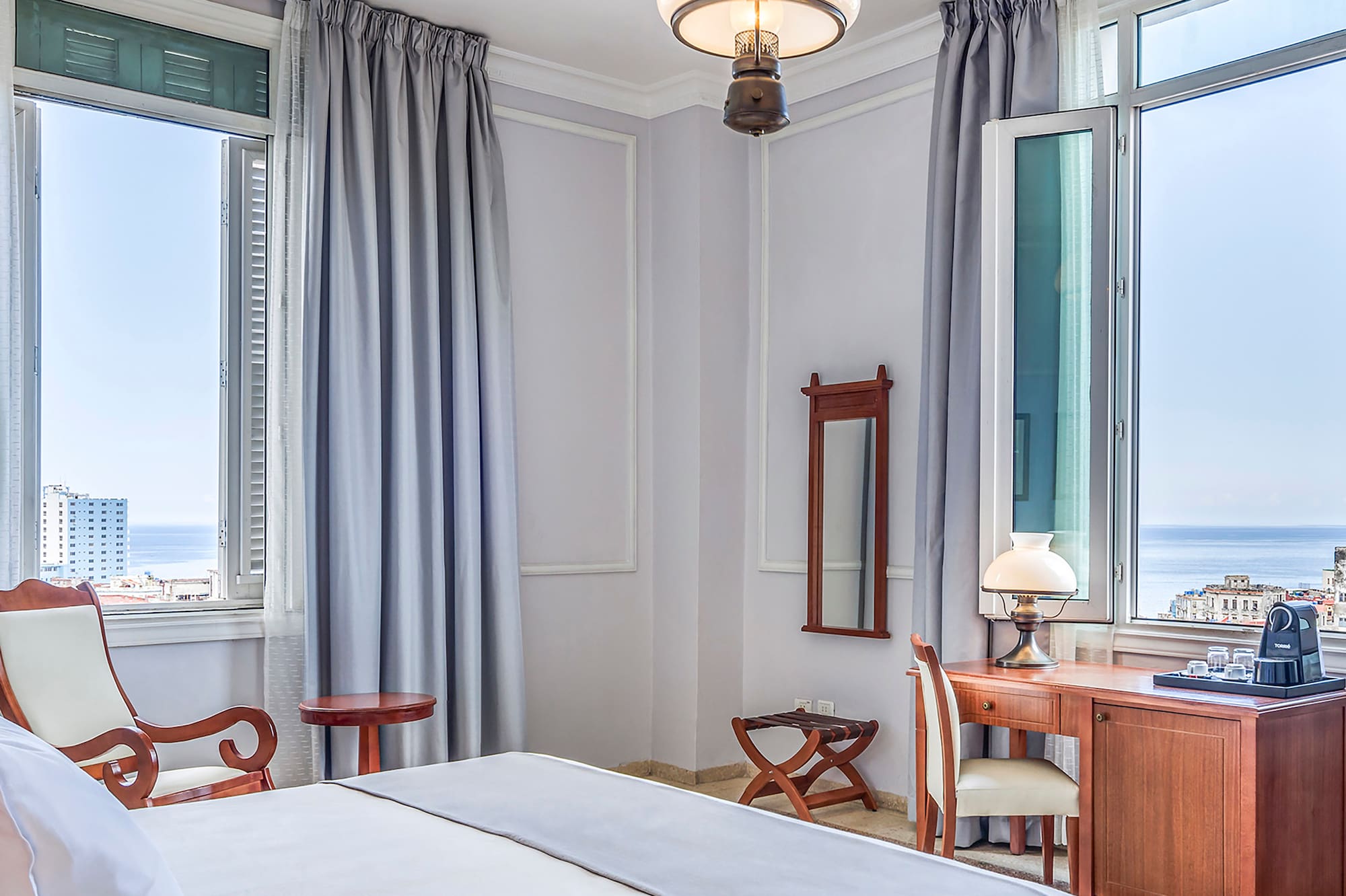 a bedroom with a bed and a desk and chair