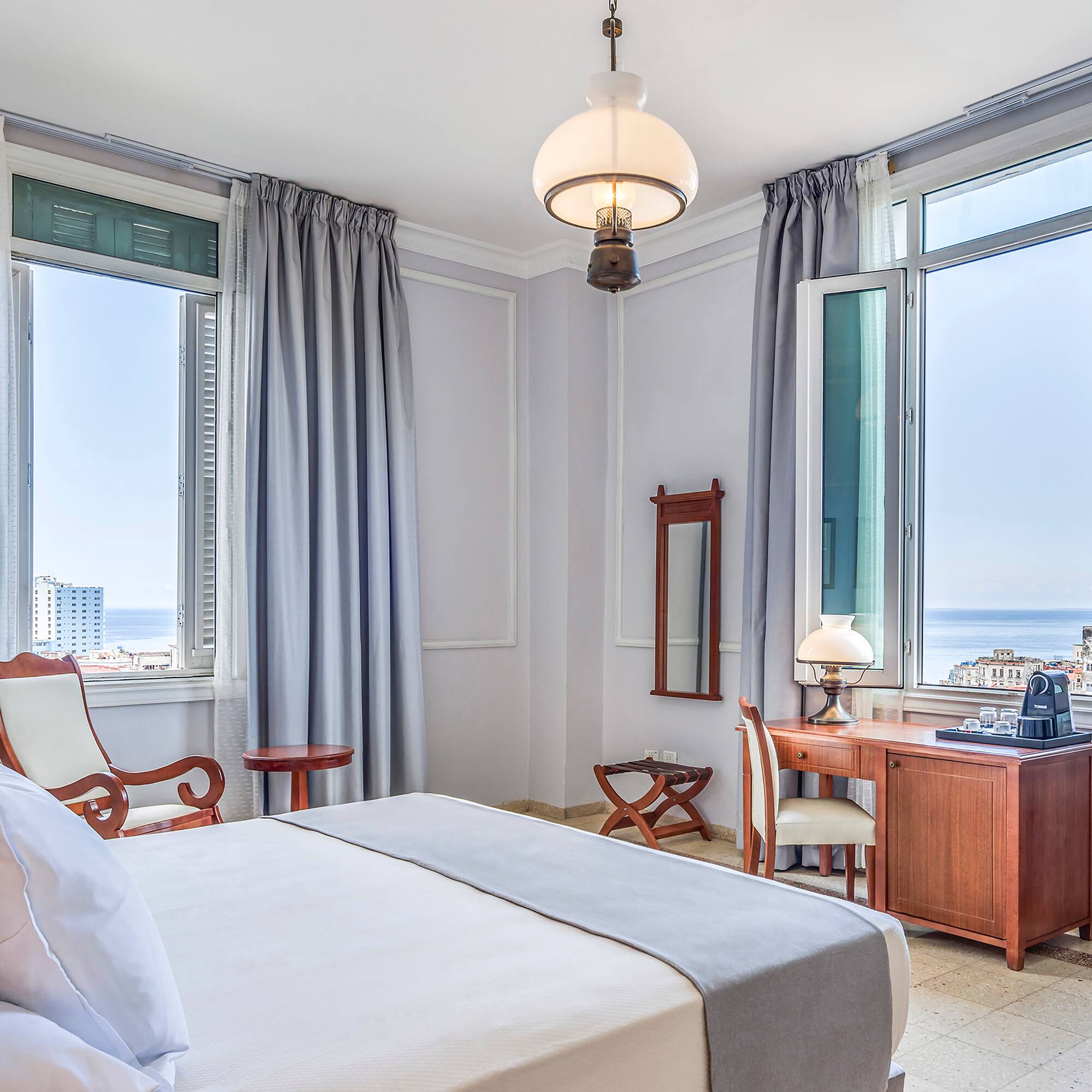 a bedroom with a bed and a desk and chair